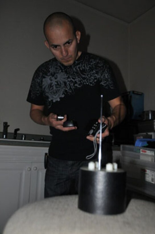 Senior Airman Jose Mora, 452nd Aerospace Medicine Squadron, conducts a paranormal investigation using various pieces of equipment to detect energy. Mora considers himself sensitive to paranormal activities and pursues his passion in the paranormal whenever he is able. (U.S. Air Force photo/Linda Welz)