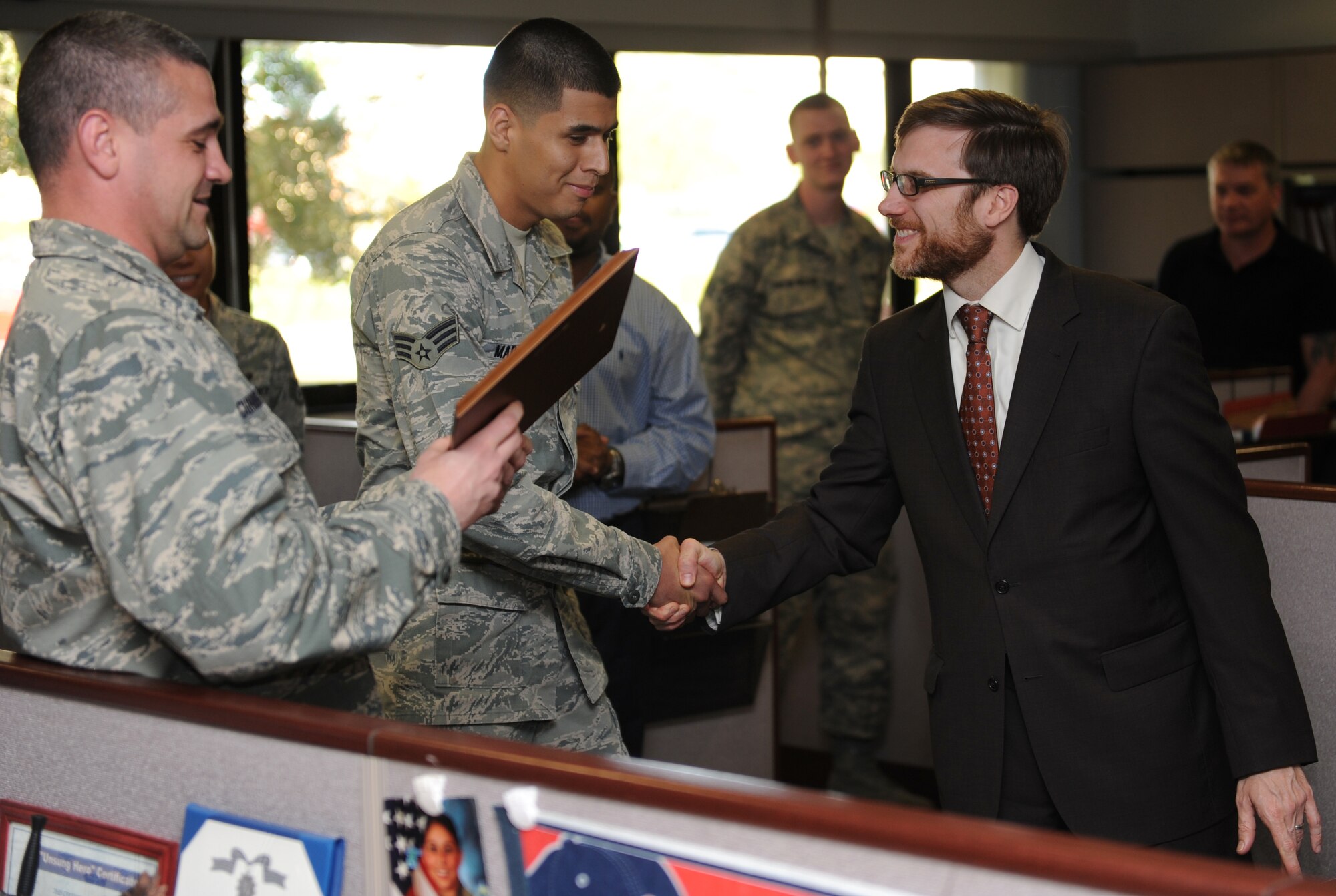 Senior Airman Alfredo Marquez, 1st Special Operations Comptroller Squadron budget analysis, shakes hands with Dr. Jamie Morin, Assistant Secretary of the Air Force Financial Management comptroller, during a visit to Hurlburt Field, Fla., Nov. 5. Morin is the highest ranking financial management official in the Air Force. (U.S. Air Force photo/Senior Airman Kentavist P. Brackin)
