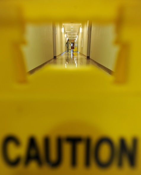 Airman 1st Class Joseph Dizon, 5th Force Support Squadron personnel customer service representative, mops a hallway of Dorm 221 as part of Bay Orderly duty, Nov. 7, 2013. During this duty, Airmen sweep, mop, vacuum, and further detail the entire dorm building in which they reside in. (U.S. Air Force photo/Senior Airman Jose L. Hernandez)