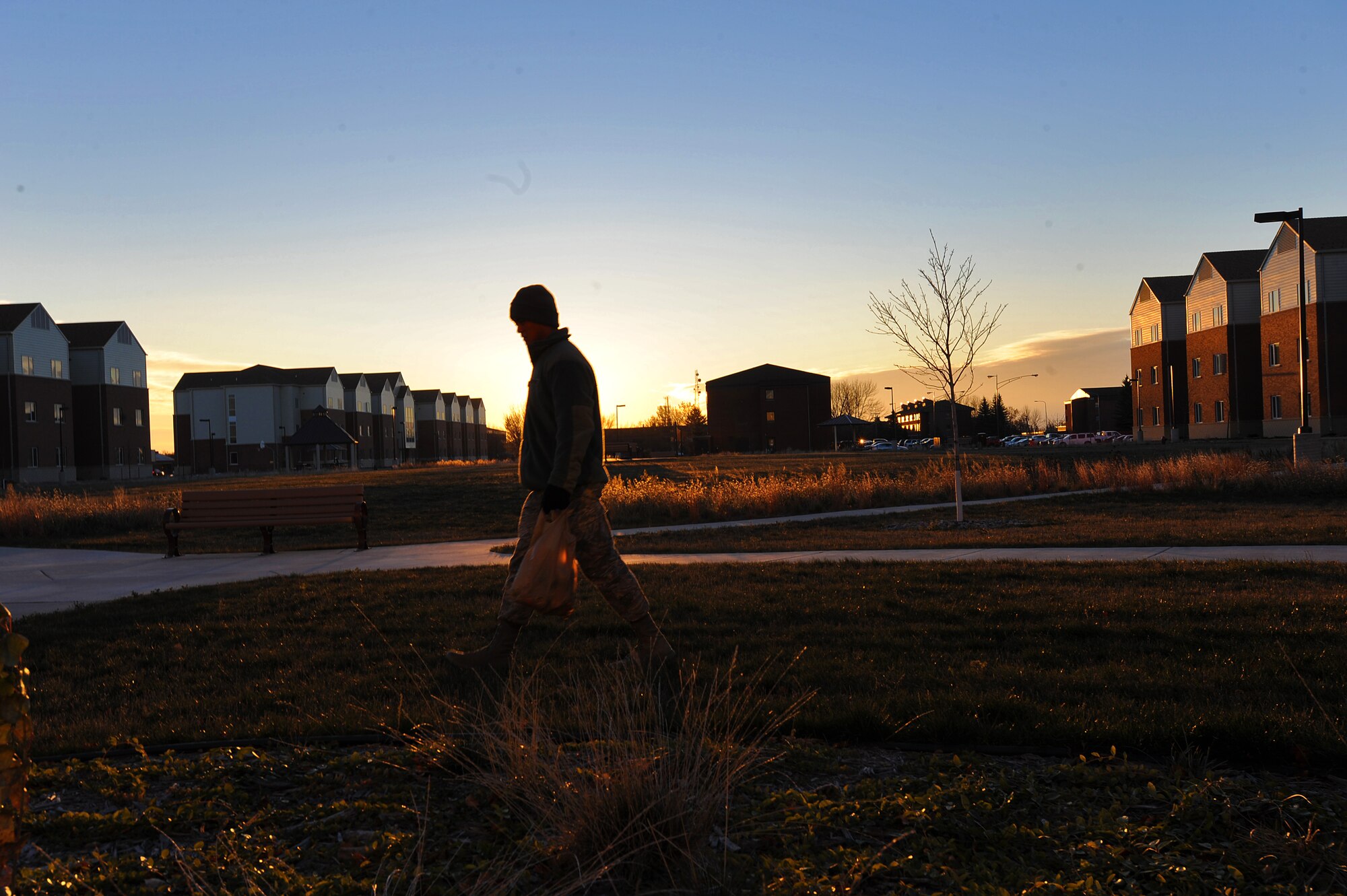 Airman 1st Class Joseph Dizon, 5th Force Support Squadron personnel customer service representative, walks the outskirts of Dorm 221 searching for miscellaneous garbage, Nov. 7, 2013. As part of his week-long duty of Bay Orderly, Dizon ensured the outside of his dorm was clean and free of debris. (U.S. Air Force photo/Senior Airman Jose L. Hernandez)