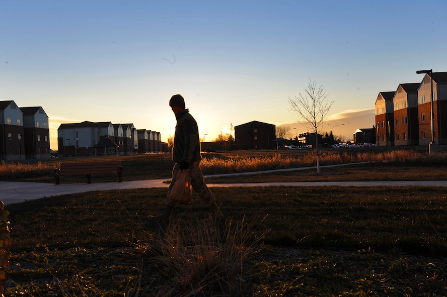 Airman 1st Class Joseph Dizon, 5th Force Support Squadron personnel customer service representative, walks the outskirts of Dorm 221 searching for miscellaneous garbage, Nov. 7, 2013. As part of his week-long duty of Bay Orderly, Dizon ensured the outside of his dorm was clean and free of debris. (U.S. Air Force photo/Senior Airman Jose L. Hernandez)