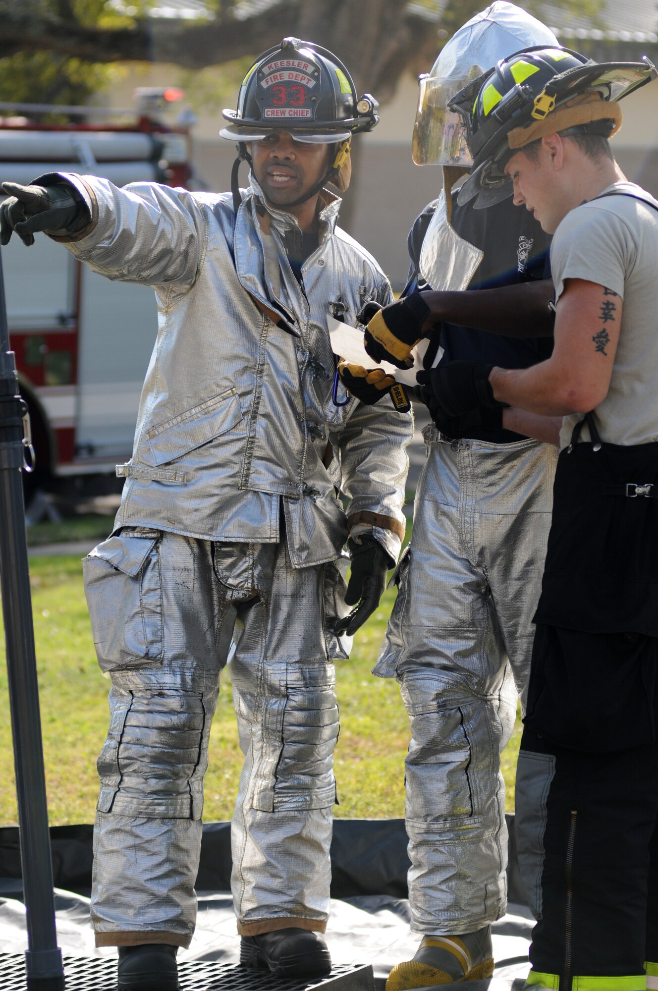 John McIntyre, Tech. Sgt. Commie Hobbs, and Senior Airman Christopher Lecomte, Keesler firefighters, set up a decontamination line for “victims” during a Chemical, Biological, Radiological, Nuclear, and high-yield Explosive exercise scenario Nov. 6, 2013, at Keesler Air Force Base, Miss.  The Force Protection Condition exercise scenario included a suspect posing as a driver making a delivery to the Locker House and spraying a chemical on a group of Airmen as they were assisting him with unloading the packages from the truck.  Immediately, the Airmen simulated receiving eye irritations, excessive sweating, chest pain, choking, and vomiting from exposure to the chemical.  (U.S. Air Force photo by Kemberly Groue)