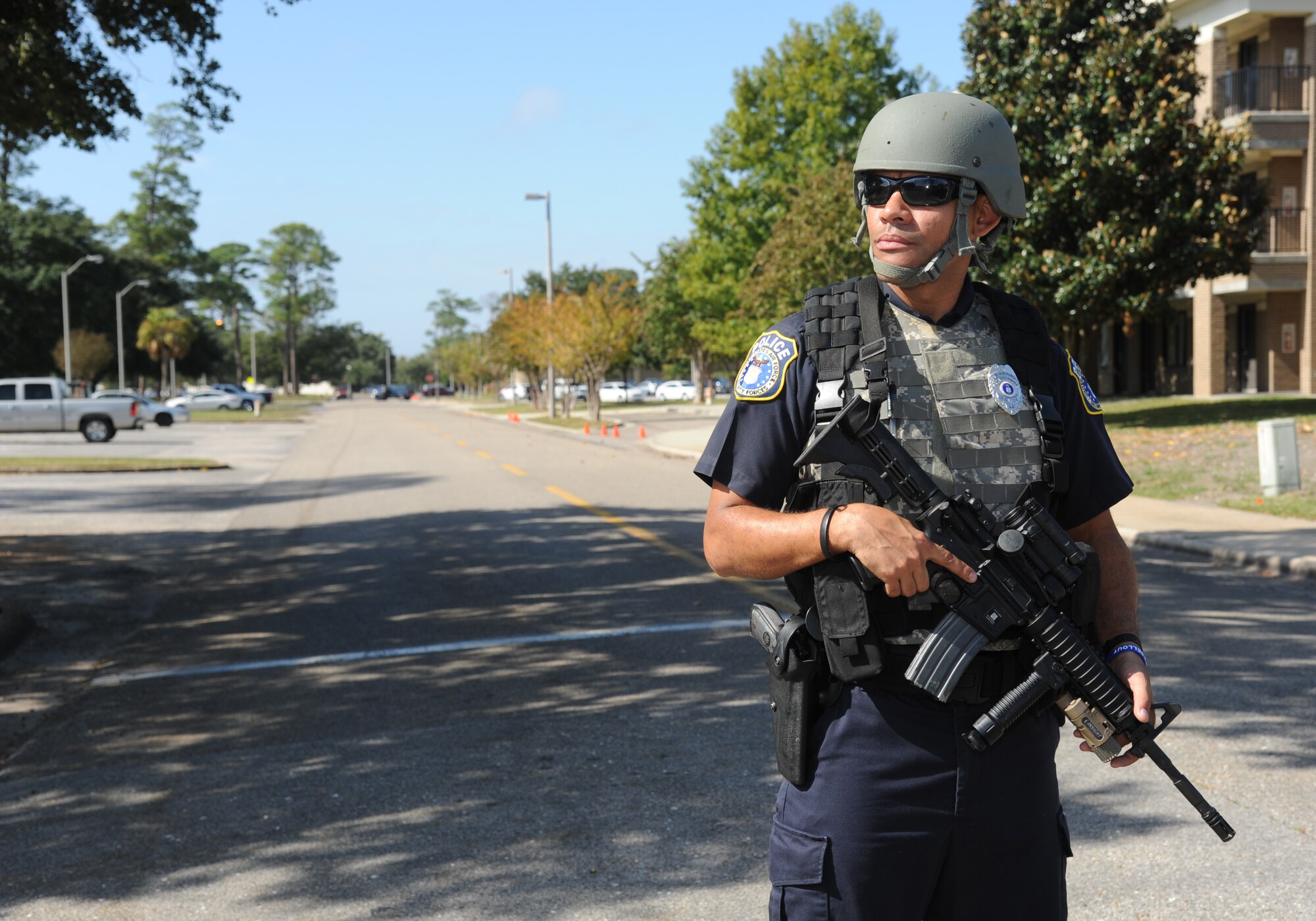 Officer Maurice Mathis, 81st Security Forces Squadron, stands guard outside of the cordon area during a Chemical, Biological, Radiological, Nuclear, and high-yield Explosive exercise scenario Nov. 6, 2013, at Keesler Air Force Base, Miss.  The Force Protection Condition exercise scenario included a suspect posing as a driver making a delivery to the Locker House and spraying a chemical on a group of Airmen as they were assisting him with unloading the packages from the truck.  Immediately, the Airmen simulated receiving eye irritations, excessive sweating, chest pain, choking, and vomiting from exposure to the chemical.  (U.S. Air Force photo by Kemberly Groue)