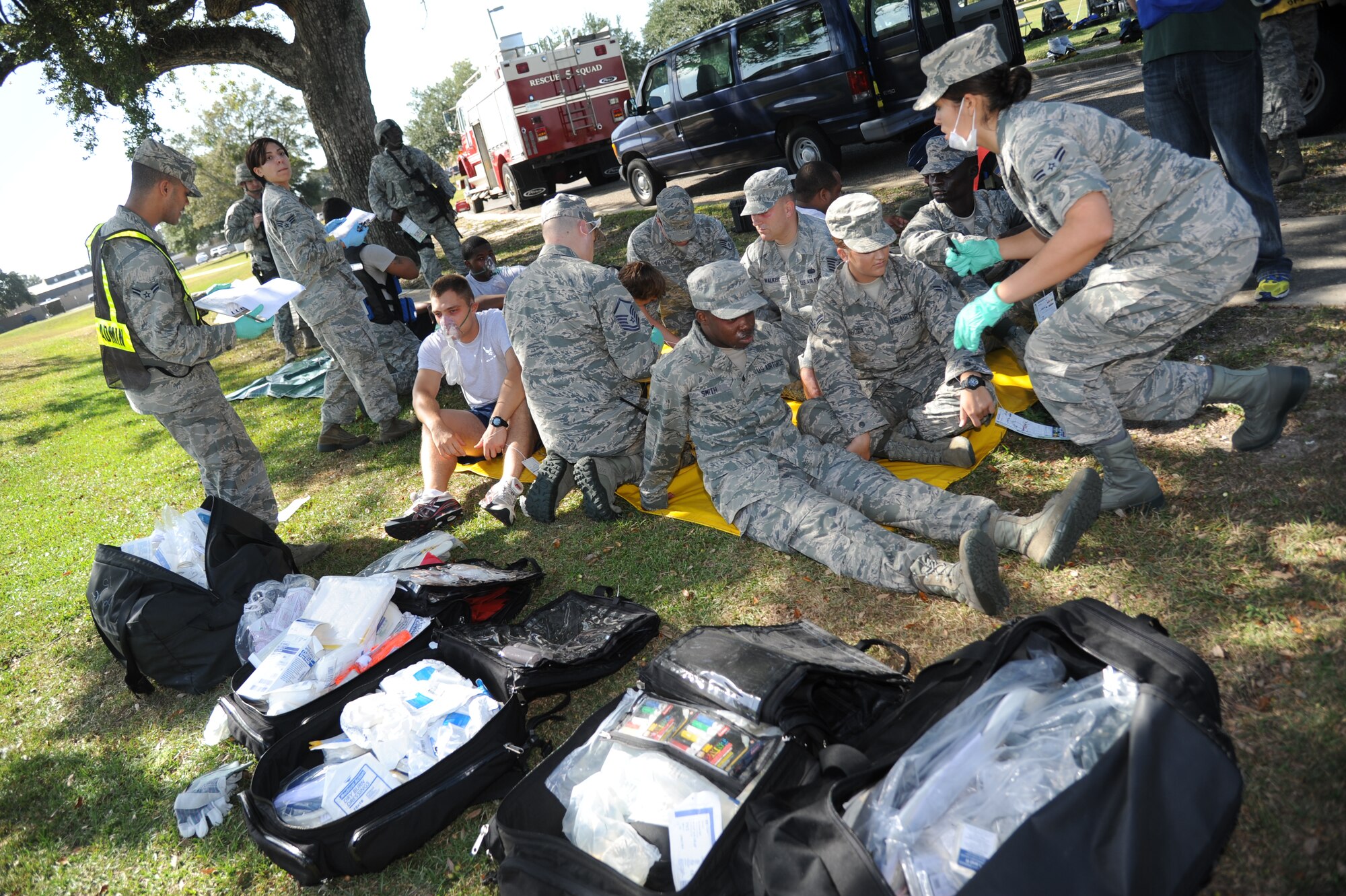 Members of the 81st Medical Group provide medical treatment inside the triage area to “victims” suffering from symptoms after being exposed to a chemical agent during a Chemical, Biological, Radiological, Nuclear, and high-yield Explosive exercise scenario Nov. 6, 2013, at Keesler Air Force Base, Miss.  The Force Protection Condition exercise scenario included a suspect posing as a driver making a delivery to the Locker House and spraying a chemical on a group of Airmen as they were assisting him with unloading the packages from the truck.  Immediately, the Airmen simulated receiving eye irritations, excessive sweating, chest pain, choking, and vomiting from exposure to the chemical.  (U.S. Air Force photo by Kemberly Groue)