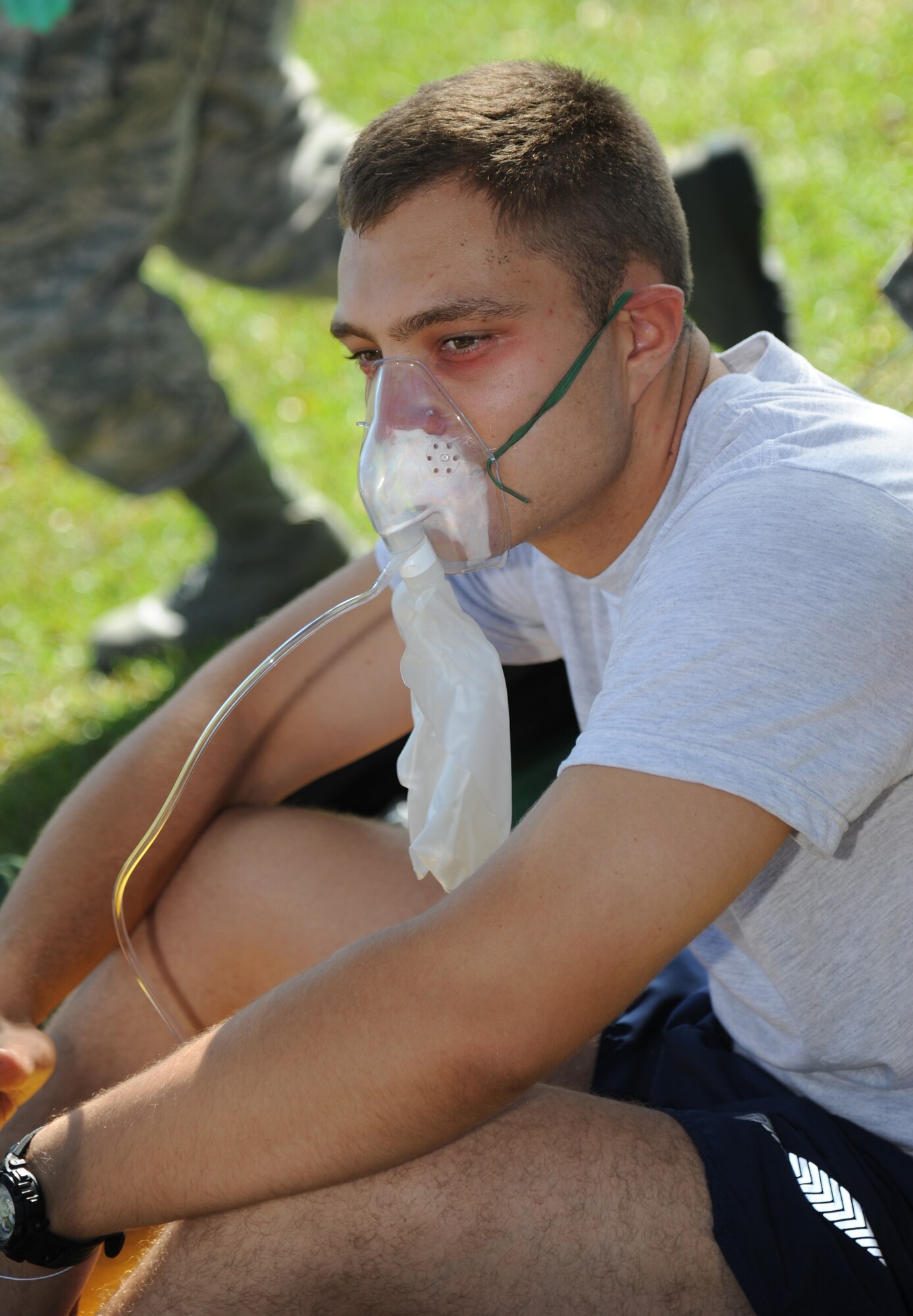 Airman 1st Class Michael Dabrowski, 338th Training Squadron, portrays a “victim” suffering from shortness of breath after being exposed to a chemical agent during a Chemical, Biological, Radiological, Nuclear, and high-yield Explosive exercise scenario Nov. 6, 2013, at Keesler Air Force Base, Miss.  The Force Protection Condition exercise scenario included a suspect posing as a driver making a delivery to the Locker House and spraying a chemical on a group of Airmen as they were assisting him with unloading the packages from the truck.  Immediately, the Airmen simulated receiving eye irritations, excessive sweating, chest pain, choking, and vomiting from exposure to the chemical.  (U.S. Air Force photo by Kemberly Groue)