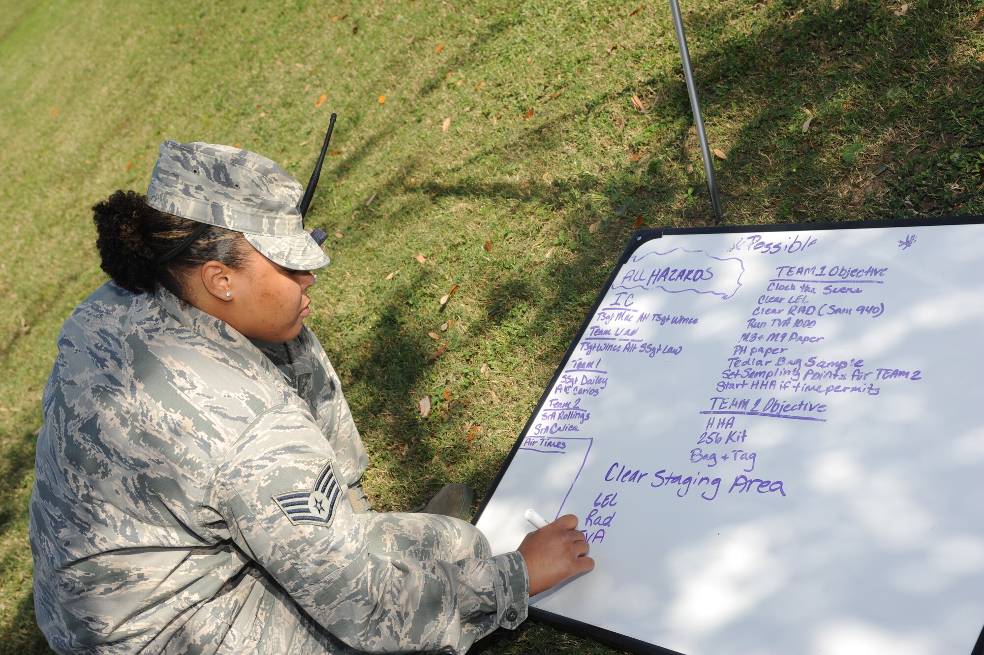 Staff Sgt. Justina Law, 81st Aerospace Medicine Squadron, logs bioenvironmental engineering team objectives during a Chemical, Biological, Radiological, Nuclear, and high-yield Explosive exercise scenario Nov. 6, 2013, at Keesler Air Force Base, Miss.  The Force Protection Condition exercise scenario included a suspect posing as a driver making a delivery to the Locker House and spraying a chemical on a group of Airmen as they were assisting him with unloading the packages from the truck.  Immediately, the Airmen simulated receiving eye irritations, excessive sweating, chest pain, choking, and vomiting from exposure to the chemical. (U.S. Air Force photo by Kemberly Groue)