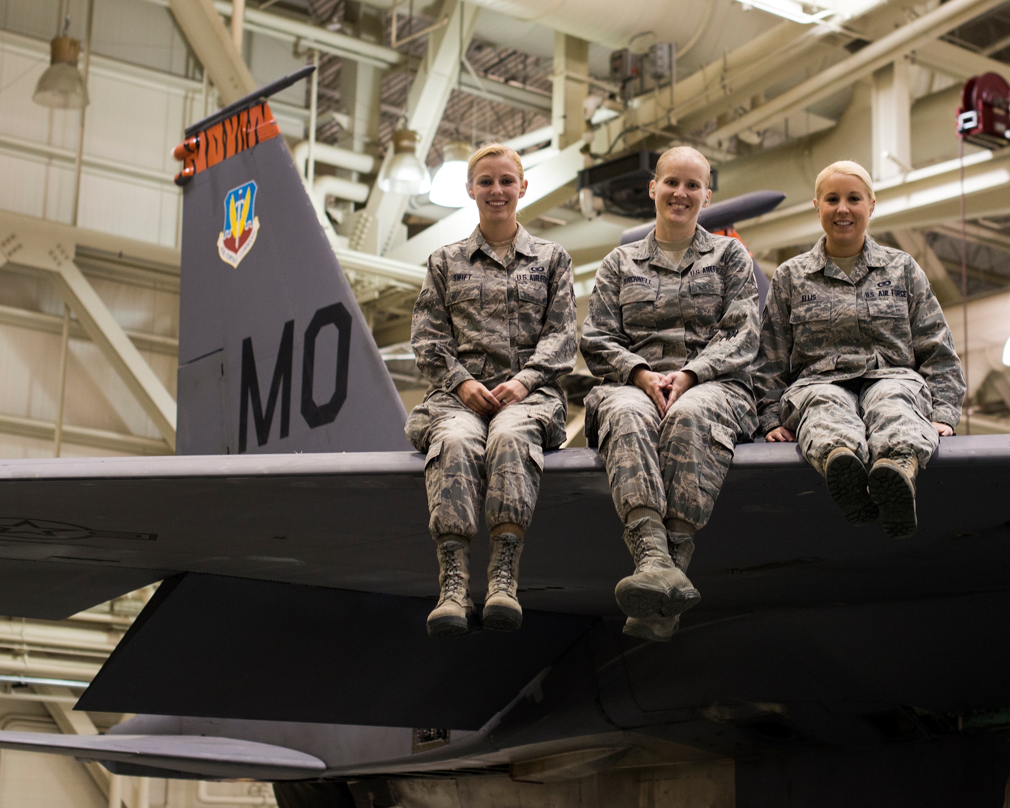 Airman 1st Class Gabrielle Swift, Airman 1st Class Rachel Burchnell and Senior Airman Jamie Ellis, 366th Operations Support Squadron Airmen, gather in a maintenance hangar at Mountain Home Air Force Base, Idaho, Nov. 7, 2013, and reflect on intervening and preventing a potential sexual assault at a Boise State University football game in October. “These Airmen are heroes in every sense of the word,” said Lt. Col. Damon Anthony, 366th OSS commander. “They demonstrated incredible moral courage in a difficult situation and diffused a bad situation.” (U.S. Air Force photo by Master Sgt. Kevin Wallace/RELEASED)