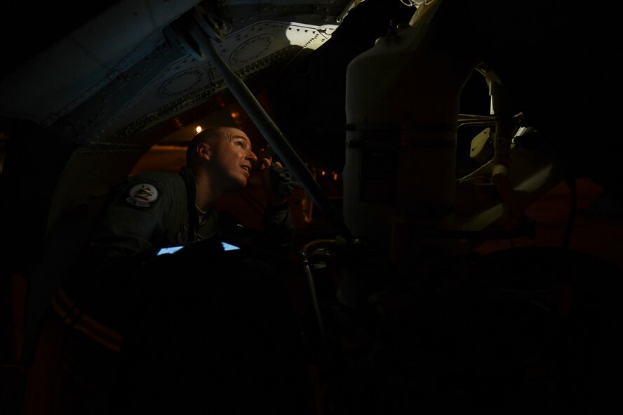 Capt. Nicholas Johnson, 20th Bomb Squadron, inspects a landing gear on a B-52H Stratofortress on Barksdale Air Force Base, La., Oct. 29, 2013. Johnson and his fellow aircrew made a simulated emergency landing in an isolated area with no maintenance support around. Aircrew are capable of performing basic maintenance on the aircraft in emergency situations. (U.S. Air Force photo/Senior Airman Micaiah Anthony)