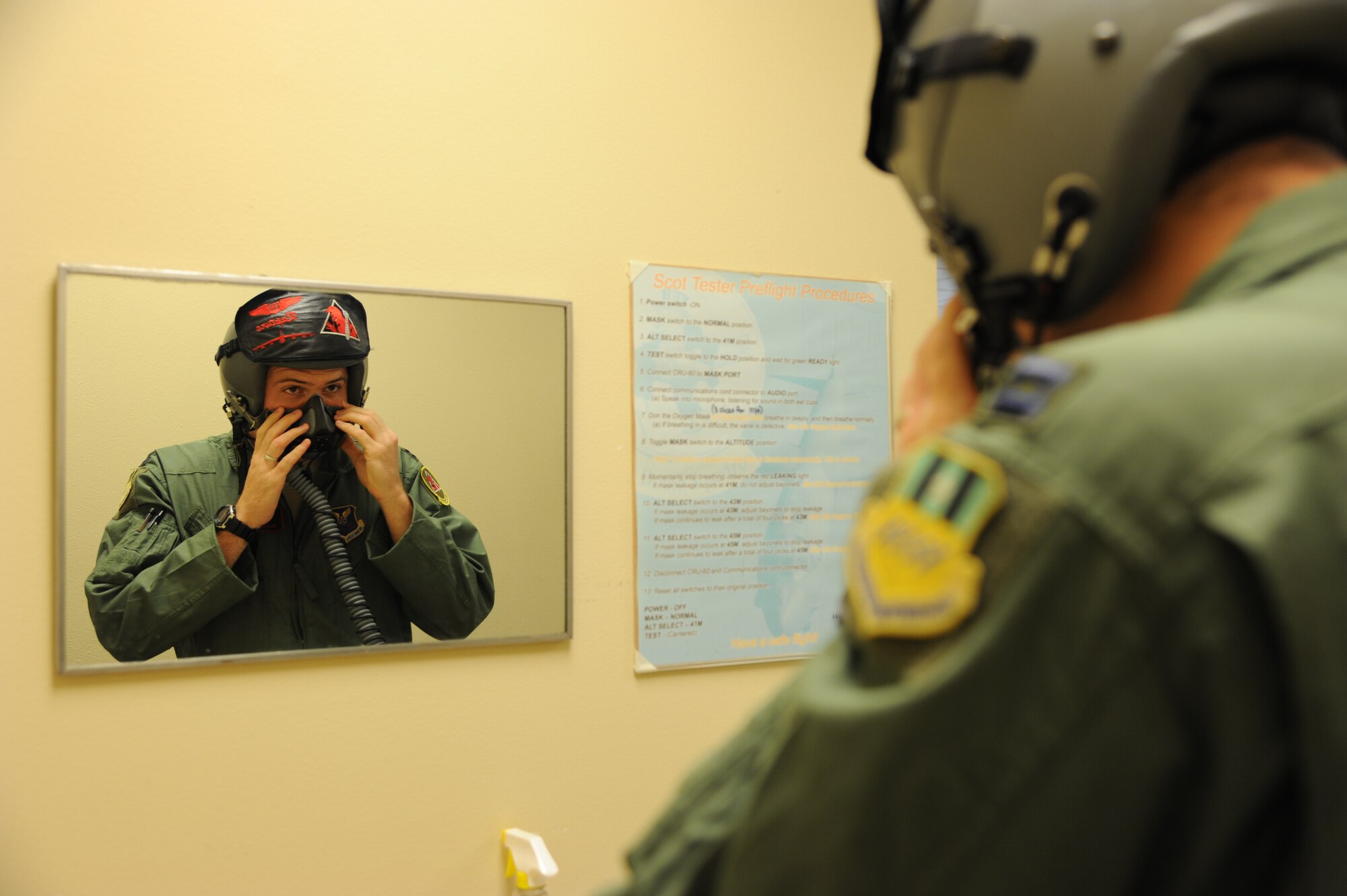 An Aircrew member checks for leaks in his mask on Barksdale Air Force Base, La., Oct. 29, 2013. Aircrew are provided with proper lifesaving equipment used in the event of a crash including oxygen masks, survival vests, anti-exposure suits, life preservers and night vision goggles. (U.S. Air Force photo/Senior Airman Joseph A. Pagán Jr.)