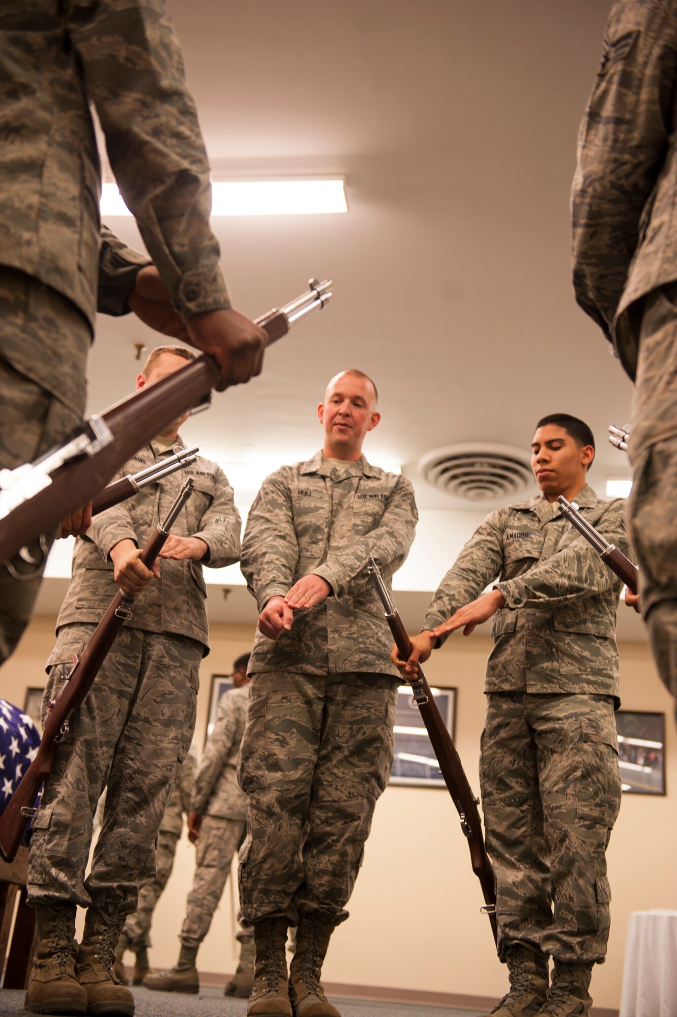 Staff Sgt. Joshua Hull, 5th Force Support Squadron installation Honor Guard Non Commissioned Officer in charge, demonstrates the proper technique of a ceremonial rifle drill to Airmen of the Minot Air Force Base Honor Guard, Nov. 6, 2013. Hull spends time every week to train Airmen on ceremonial drill moves. (U.S. Air Force photo/Airman 1st Class Apryl Hall)
