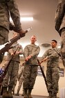 Staff Sgt. Joshua Hull, 5th Force Support Squadron installation Honor Guard Non Commissioned Officer in charge, demonstrates the proper technique of a ceremonial rifle drill to Airmen of the Minot Air Force Base Honor Guard, Nov. 6, 2013. Hull spends time every week to train Airmen on ceremonial drill moves. (U.S. Air Force photo/Airman 1st Class Apryl Hall)