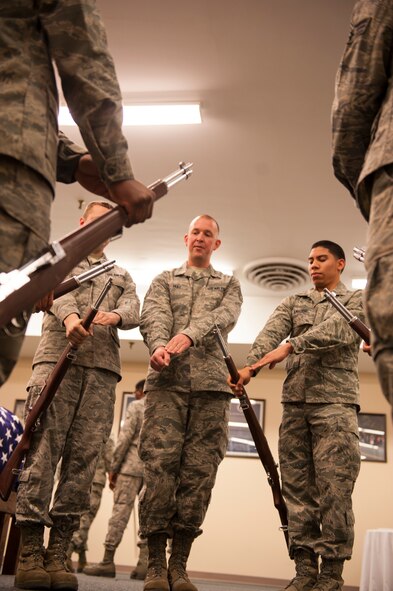 Staff Sgt. Joshua Hull, 5th Force Support Squadron installation Honor Guard Non Commissioned Officer in charge, demonstrates the proper technique of a ceremonial rifle drill to Airmen of the Minot Air Force Base Honor Guard, Nov. 6, 2013. Hull spends time every week to train Airmen on ceremonial drill moves. (U.S. Air Force photo/Airman 1st Class Apryl Hall)