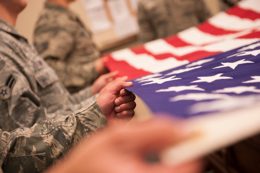 Minot Air Force Base Honor Guardsmen practice flag folding, Nov. 6, 2013. The Airmen of Minot AFB’s Honor Guard come together once a week to practice perfecting their ceremonial drills. (U.S. Air Force photo/Airman 1st Class Apryl Hall)