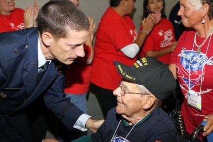 Brig. Gen. Robert J. Skinner, Deputy Commander of Air Forces Cyber, greets a World War II veteran at Baltimore Washington International Airport Sept. 28. Nearly 400 veterans from World War II, the Korean War and the Vietnam War were greeted by memers of the Air Forces Cyber as they visited Washintton, D.C., to visit their respective memorials. (Courtesy photo)