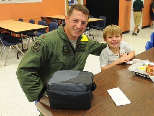 Maj. Eric Gamuaf, Air Force Special Operations Command aircrew training instructor, poses for a photo with Keegan, a 1st grader at Liza Jackson Preparatory School, during their mentoring session Oct. 30. The mentor program gives Airmen an opportunity to make a lasting impression on children from kindergarten through 12th grade at Okaloosa District Schools. (U.S. Air Force photo by Senior Airman Krystal M. Garrett) 
