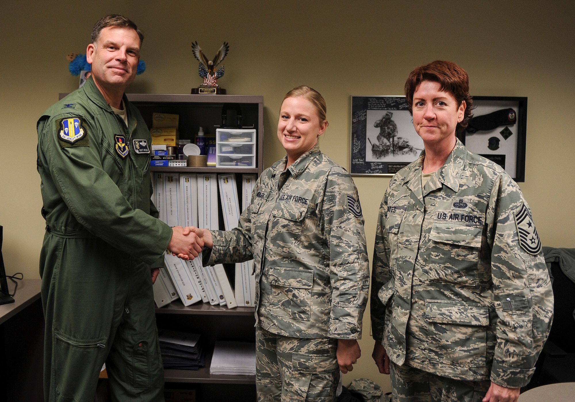 Tech. Sgt. Amanda Standley, 314th Maintenance Group unit training manager, is congratulated by Col. Scott Brewer, 314th Airlift Wing commander, and Chief Master Sgt. Andrea Gates, 314th AW command chief, for her selection as Combat Airlifter of the Week Nov. 4, 2013, at Little Rock Air Force Base, Ark. Standley, an Enterprise, Ala, native, saved the 314th MXG nearly $10,000 by organizing a mobile training team. (U.S. Air Force photo by Staff Sgt. Jake Barreiro)