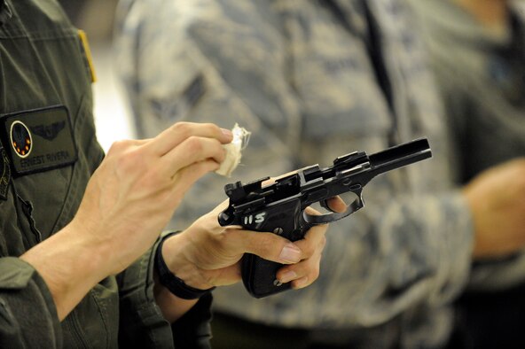 A student cleans an M9 pistol before returning the weapon at Hurlburt Field, Fla., Nov. 5, 2013. Cleaning the weapon is the final step of the M9 certification course.  Students are required to pass the course for various reasons like deployment readiness, annual certification, permanent changes in station, proficiency, and sustainment shooting. (U.S. Air Force photo/Staff Sgt. Jeff Andrejcik)