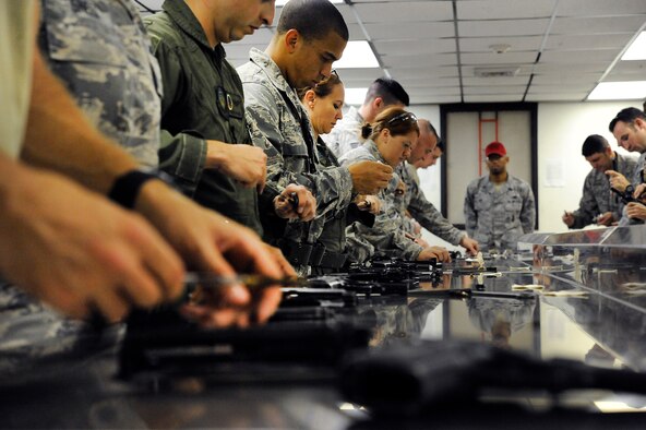 Students clean their M9 pistol before returning it at Hurlburt Field, Fla., Nov. 5, 2013. Cleaning the weapon is the final step of the M9 certification course. Students are required to pass the course for various reasons such as deployment readiness, annual certification, permanent changes in station, proficiency, and sustainment shooting. (U.S. Air Force photo/Staff Sgt. Jeff Andrejcik)