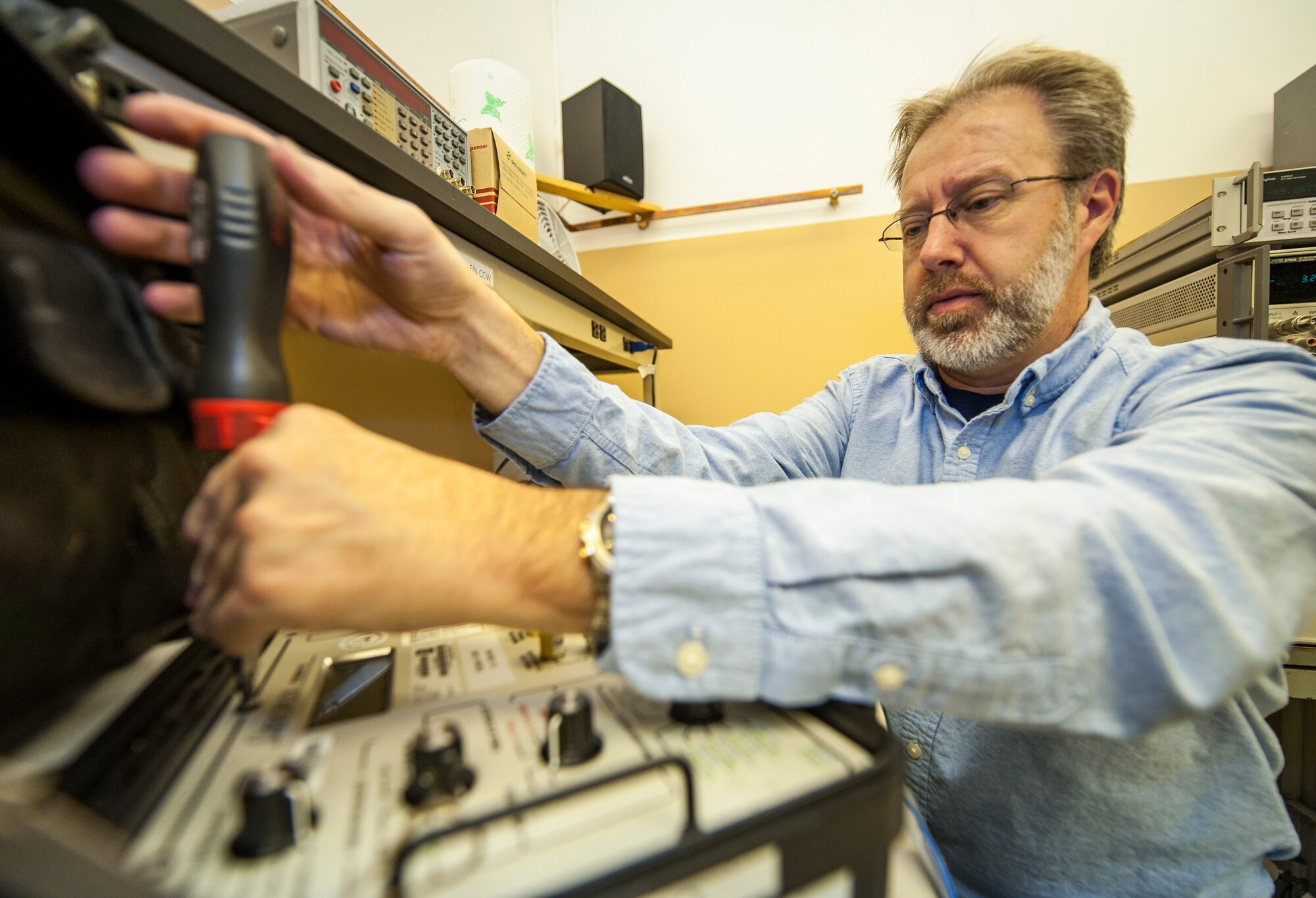 Steve Skory, a 92nd Maintenance Squadron Precision Measurement Equipment Laboratory electric technician and a Manistee, Mich., native, troubleshoots a fuel quantity tester at Fairchild Air Force Base, Wash., Nov. 5, 2013. Maintenance uses these testers by inserting a probe into the fuel tank to ascertain how much fuel is in the tank. PMEL is responsible for calibrating equipment used in virtually every phase of maintenance for nearly every piece of equipment the Air Force operates. (U.S. Air Force photo by Staff Sgt. Benjamin W. Stratton/Released)