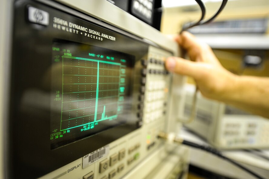 Mike Olson, a 92nd Maintenance Squadron Precision Measurement Equipment Laboratory electric technician and a Forest Hills, Md., native, isolates signals and corrects the bandwidth using filters on navigation equipment at Fairchild Air Force Base, Wash., Nov. 5, 2013. PMEL is responsible for calibrating equipment used in virtually every phase of maintenance for nearly every piece of equipment the Air Force operates. (U.S. Air Force photo by Staff Sgt. Benjamin W. Stratton/Released)
