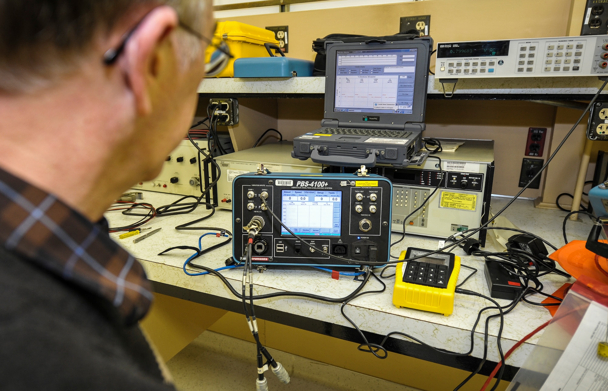 Pat McCarthy, a 92nd Maintenance Squadron Precision Measurement Equipment Laboratory lead technician and a Milwaukee native, calibrates a device used to check engine vibration on KC-135 Stratotankers at Fairchild Air Force Base, Wash., Nov. 5, 2013. PMEL is responsible for calibrating equipment used in virtually every phase of maintenance for nearly every piece of equipment the Air Force operates. (U.S. Air Force photo by Staff Sgt. Benjamin W. Stratton/Released)