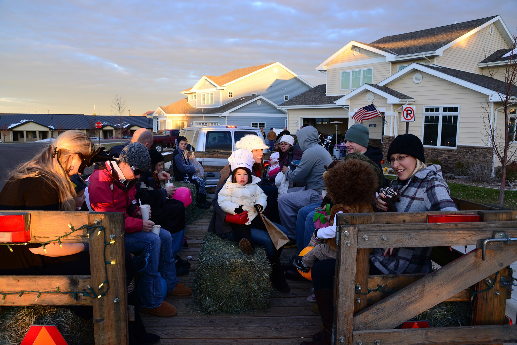 Team Malmstrom members catch a ride on the hay wagon from the command chief master sergeants’ Halloween party to the commanders’ party Oct. 31.The wagon offered several staging areas for trick-or-treaters who needed a lift from one party to another. (U.S. Air Force photo/Airman 1st Class Collin Schmidt)