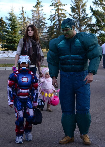 Lt. Col. Louis Papa, 341st Medical Operations Squadron psychiatrist, and his son, dressed as the Iron Patriot, have fun trick-or-treating together during the commanders’ Halloween party. “The event was the best we’ve seen in over 10 years,” said Papa. “I’ve never seen so many happy kids. It’s great that the command gets involved and their visibility during the event really boosts the morale.” (U.S. Air Force photo/Airman 1st Class Collin Schmidt)