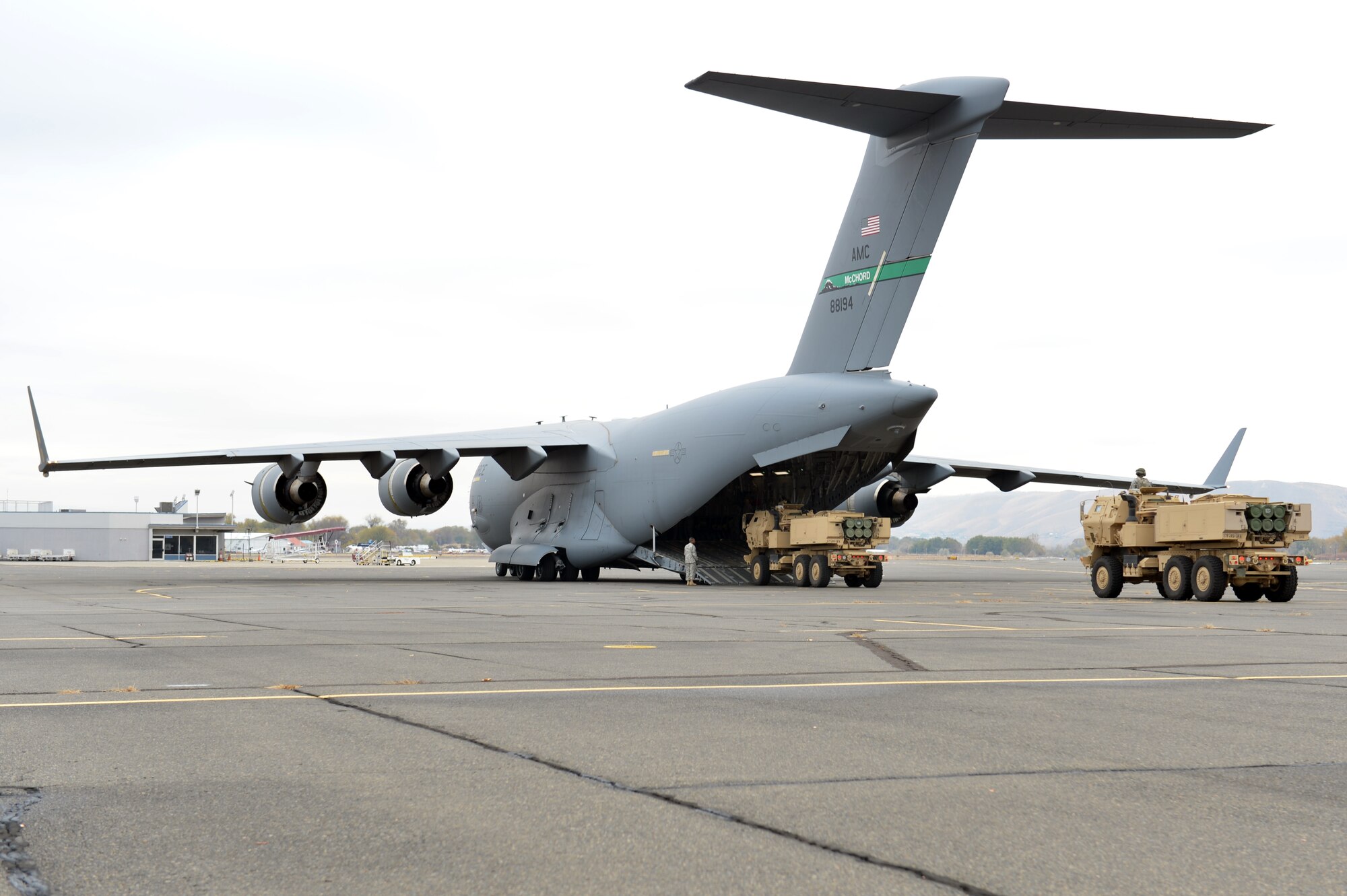 Two High Mobility Artillery Rocket System vehicles are loaded onto a C-17 Globemaster III aircraft after a simulated firing exercise, Nov. 5, 2013, at Moses Lake, Wash. The HIMARS and C-17 units, both from Joint Base Lewis-McChord, Wash., partnered for the two-day exercise. (U.S. Air Force photo/Staff Sgt. Jason Truskowski)