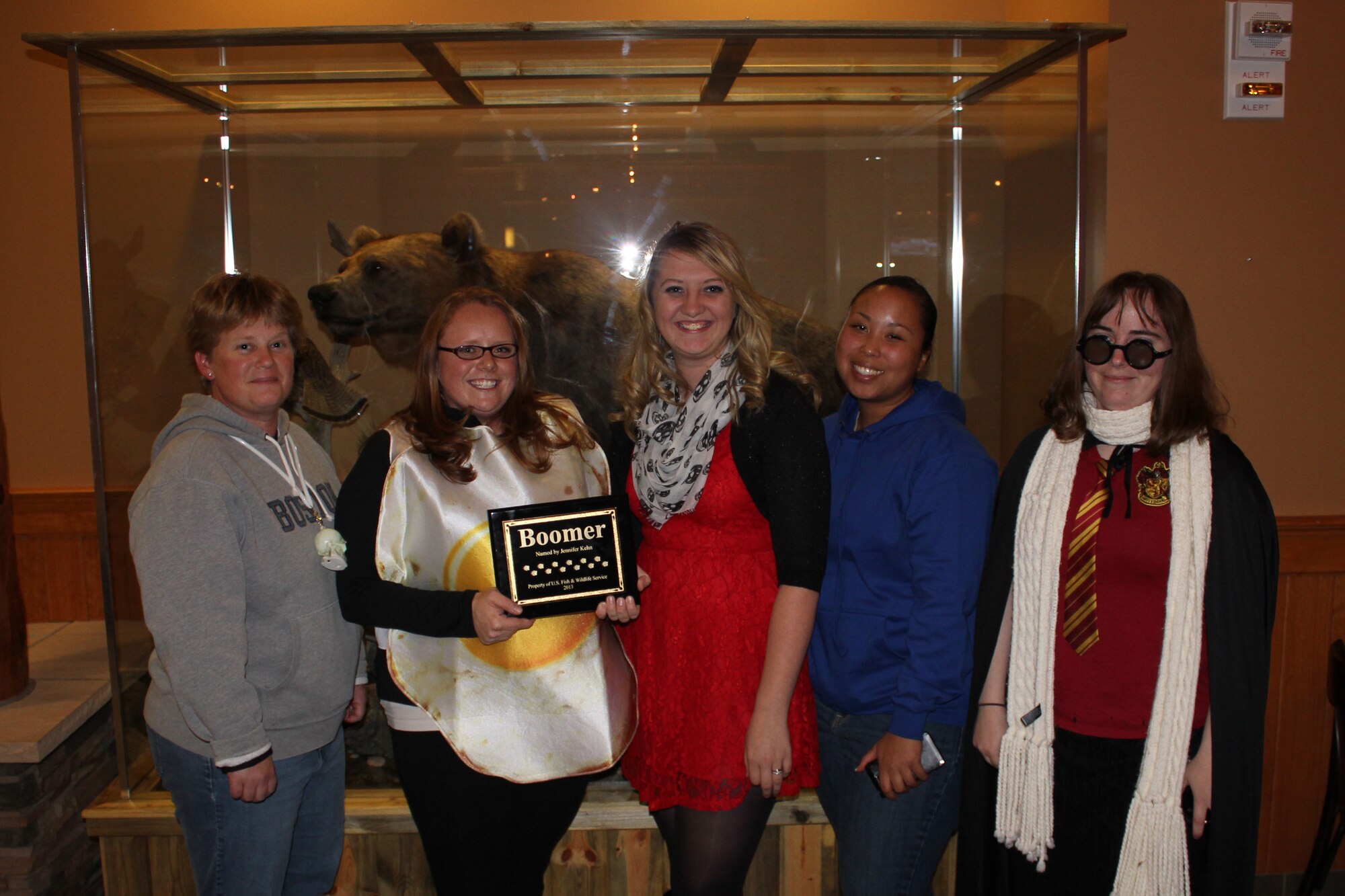 Tech. Sgt. Kristen Kehn, 341st Medical Operations Squadron bioenvironmental NCO in charge (second from left), receives a plaque for winning the Name the Bear contest during a Halloween party at the Grizzly Bend on Oct. 31. The bear, now named Boomer, was donated by U.S. Fish and Wildlife Service. Kehn’s name received the most “likes” on Facebook with the help from (pictured from left to right) Tech. Sgt. Kristen Marfa, 341st MDOS bioenvironmental technician; Airman 1st Class Elizabeth Hall, 341st MDOS medical technician; Senior Airman Michelle Smith, 341st MDOS bioenvironmental technician; and Senior Airman Sheral Bair, 341st Logistics Readiness Squadron member. (Courtesy photo)