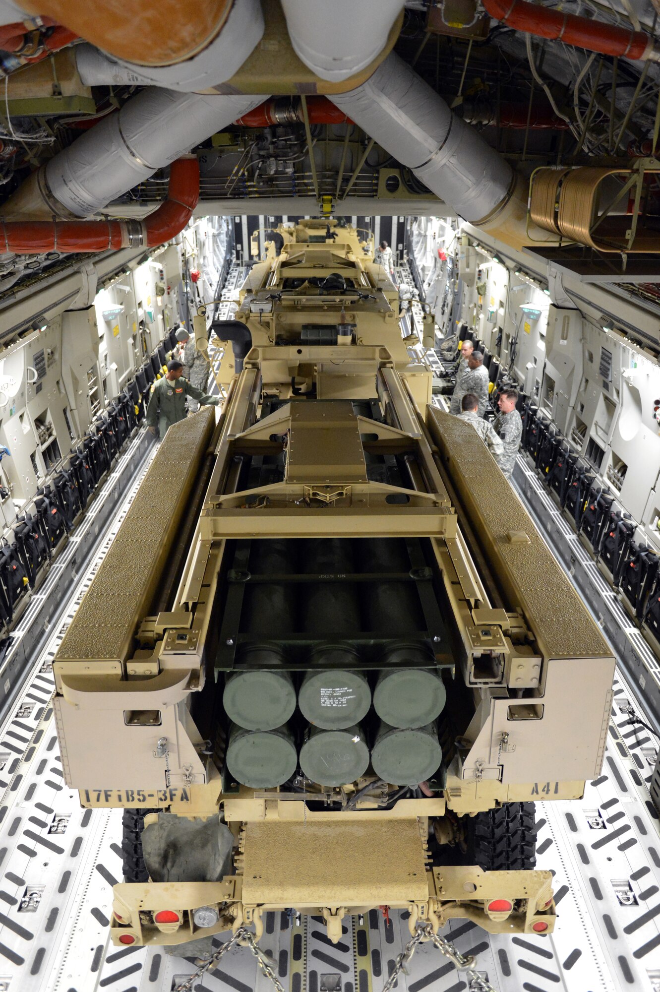 Two High Mobility Artillery Rocket System vehicles are chained down in a C-17 Globemaster III aircraft prior to take off, Nov. 5, 2013, at Joint Base Lewis-McChord, Wash. The HIMARS vehicles were flown to Moses Lake, Wash. as part of a two-day, joint exercise with Air Force and Army units from JBLM. (U.S. Air Force photo/Staff Sgt. Jason Truskowski)