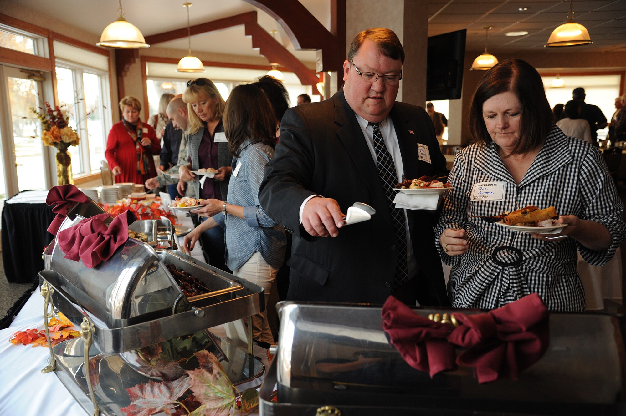 People attending the Great Falls Great Friends program kickoff get plates of hors d’oeuvres before being briefed about the program Oct. 30 at Meadowlark Country Club.  Great Falls Chamber of Commerce members and Malmstrom leadership attended the event to learn about the benefits of the program.  (U.S. Air Force photo/Senior Airman Cortney Paxton)