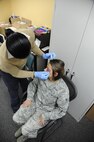 Airman 1st Class Kaitlyn Mallard, 359th Medical Group family health care administrator, receives faux bruising during Joint Base San Antonio-Randolph’s first Black Eye Project Oct. 25 at the JBSA-Randolph mental health clinic. Part of the JBSA Domestic Violence Awareness Month activities, the social experiment consisted of several participants with simulated injuries in order to gauge the community’s reaction to signs of at-home violence. (U.S. Air Force photo by Airman 1st Class Alexandria Slade)