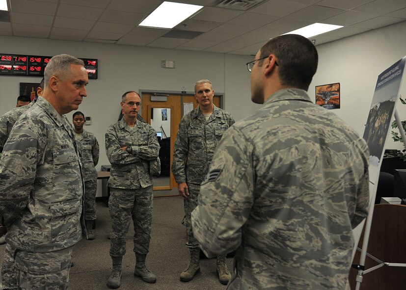 (From left to right) Maj. Gen. Frederick H. “Rick” Martin, U.S. Air Force Expeditionary Center commander and USAF EC Command Chief Master Sgt. Pete Stone, along with Col. Paul Bauman, 319th Air Base Wing commander, are briefed by Senior Airman David Stimson, a high frequency global communications system operator from the 319th Communications Squadron, about his unit’s capabilities to support the local mission Nov. 5, 2013, at Grand Forks Air Force Base, N.D. The commander’s visit included tours of the High Frequency Global Communications Systems Operations, Radar Approach Control Tower and the 319th Medical Group. (U.S. Air Force photo/Senior Airman Xavier Navarro)