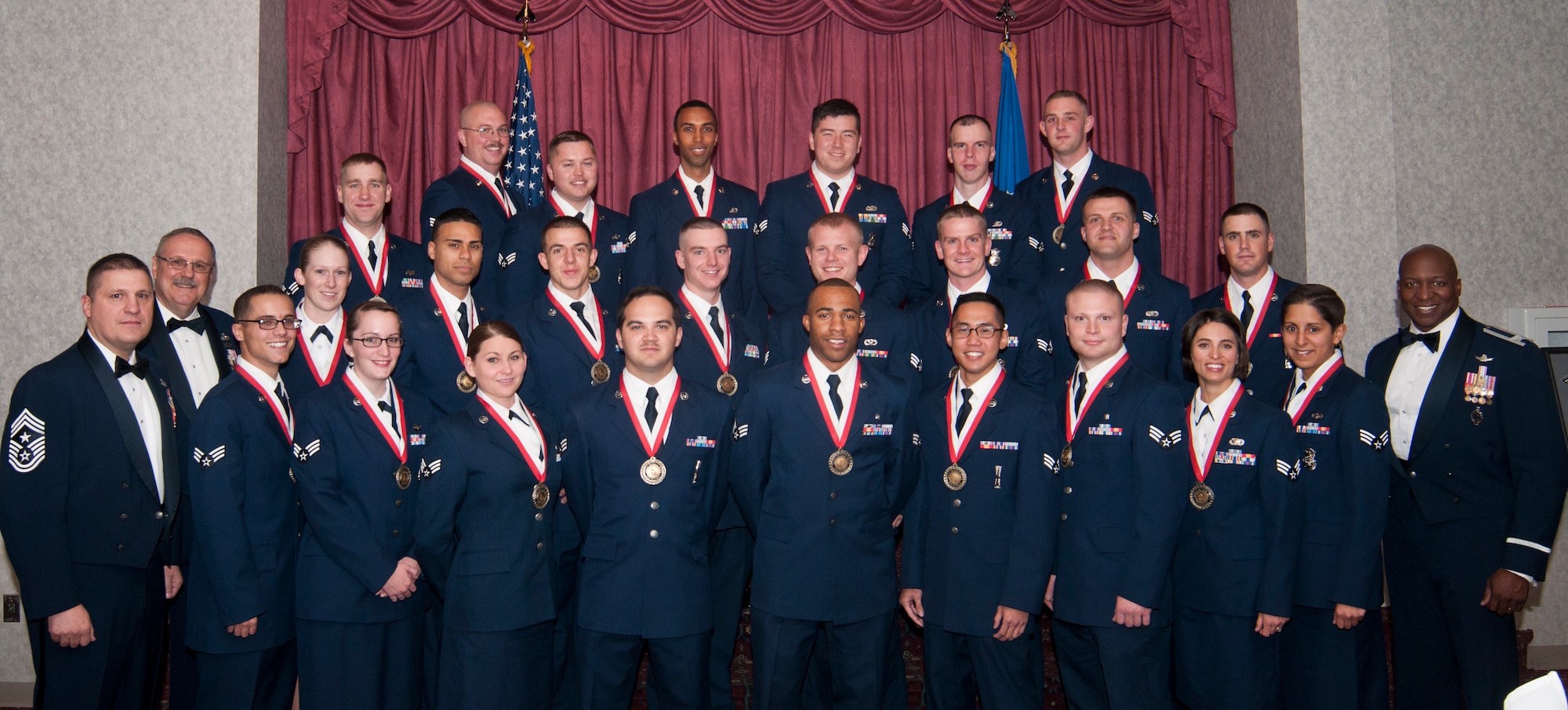 Airman Leadership School Class 14-A poses for a photograph with Chief Master Sgt. Michael Garrou, 90th Missile Wing command chief; Retired Chief Master Sgt. Daniel Yeomans, Air Force Sergeants Association International president; and Col. Carl Jones, 90th MW vice commander, prior to their graduation ceremony in the Trail’s End Club on F.E. Warren Air Force Base, Wyo., Nov. 6, 2013. (U.S. Air Force photo by Airman 1st Class Jason Wiese)