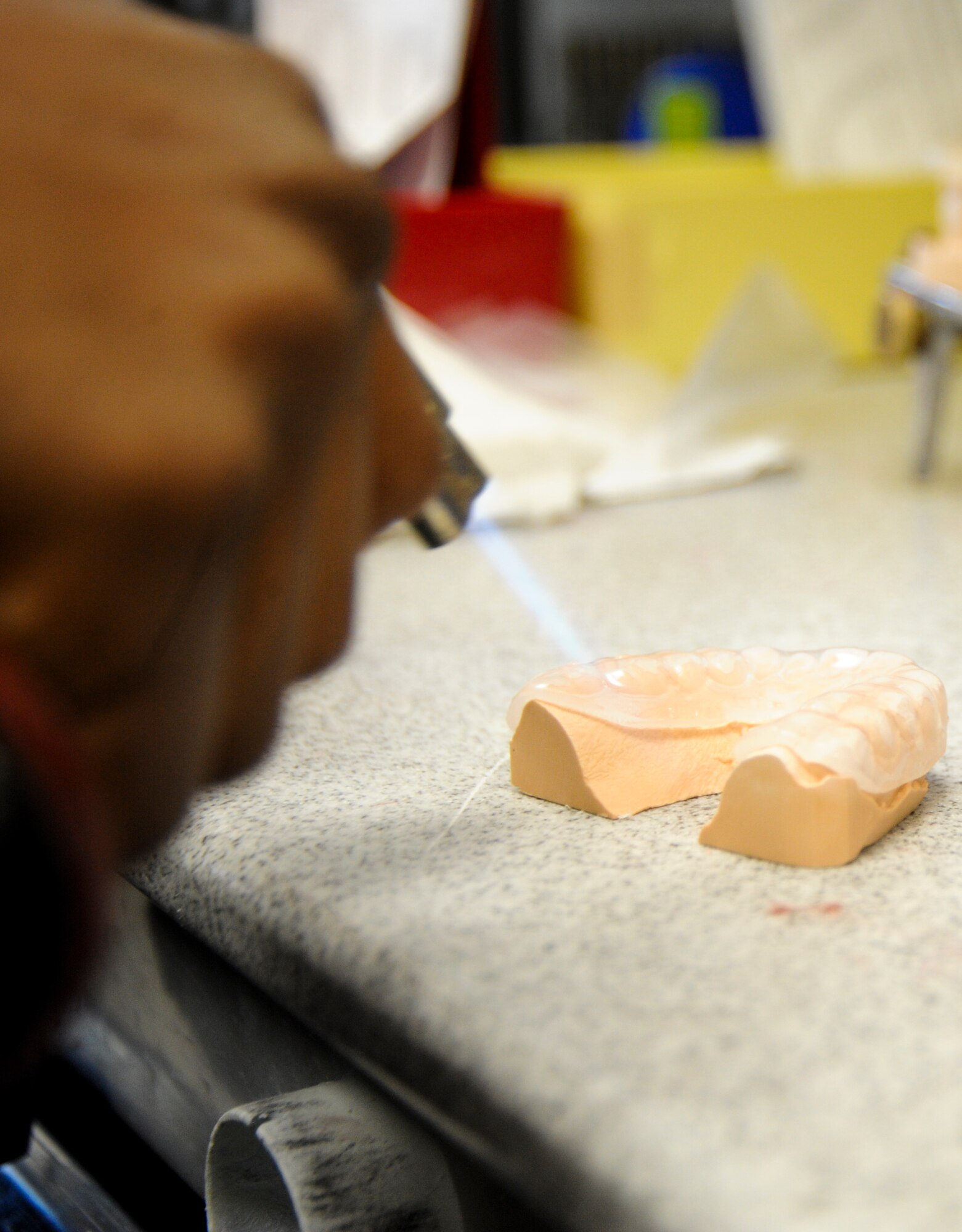 U.S. Air Force Senior Airman Tarell Walker, 355th Medical Group dental laboratory technician, heats a customized mouth guard for molding at Davis-Monthan Air Force Base, Ariz., Oct. 24, 2013. A custom mouth guard offers the most protection and is usually beneficial to athletes who play sports throughout the year. (U.S. Air Force Senior Airman Sivan Veazie/Released)