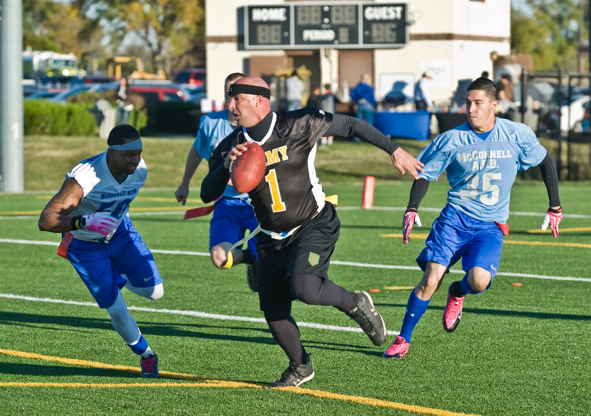 Sgt. Jason Lafasciano, Army team coach and quarterback, runs up the field Nov. 2, 2013, at McConnell Air Force Base, Kan during a flag football game. Soldiers from Fort Riley, Kan., and McConnell Airmen compete annually. The game ended in overtime when Team McConnell’s Tornadoes scored the winning touchdown. The final score was 32-26. (U.S. Air Force photo/John Linzmeier)