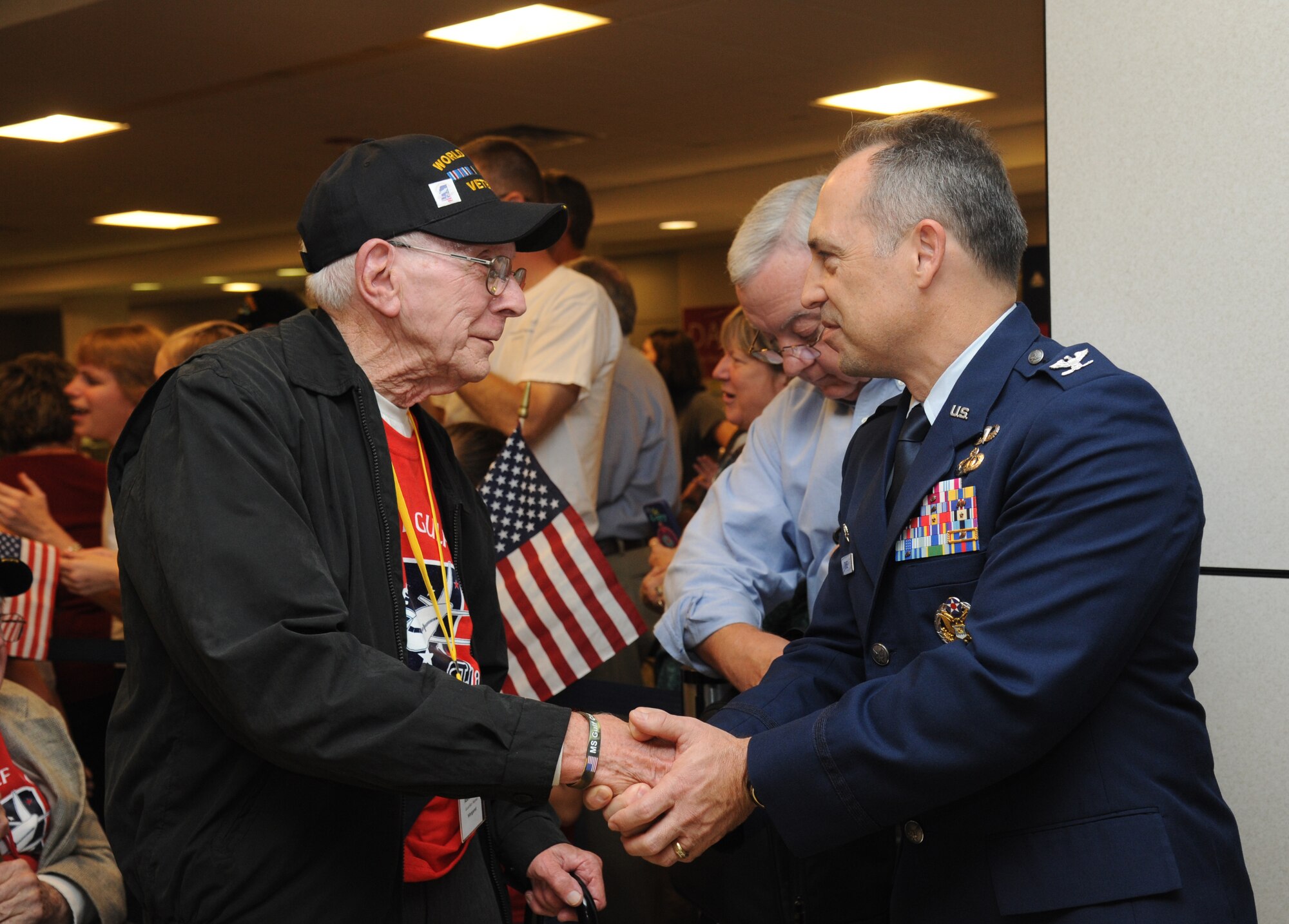 Robert Bruce, U.S. Navy World War II veteran, is welcomed back by Col. George Tombe, 81st Training Group commander, at the Gulfport/Biloxi International Airport as he arrives with the final Mississippi Gulf Coast Honor Flight from Washington, D.C., Nov. 5, 2013. The Honor Flight is a nonprofit program that sends veterans to Washington, D.C., to see national monuments. Throughout the three years of the honor flight program, 592 veterans have participated.  (U.S. Air Force photo by Kemberly Groue)