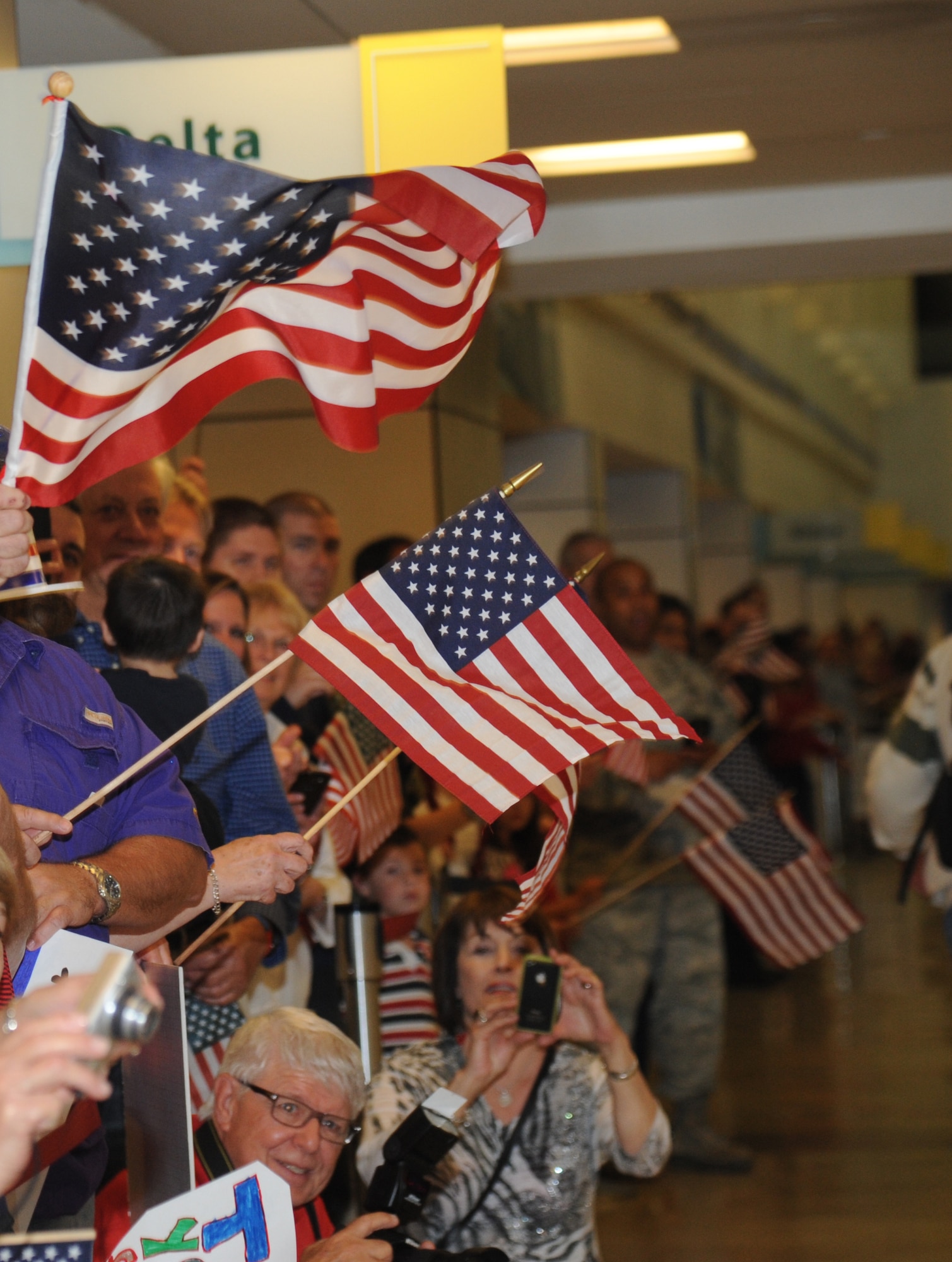 Family, friends and supporters form a welcome line along the inside of the Gulfport/Biloxi International Airport to welcome back World War II veterans with the final Mississippi Gulf Coast Honor Flight from Washington, D.C., Nov. 5, 2013. The Honor Flight is a nonprofit program that sends veterans to Washington, D.C., to see national monuments. Throughout the three years of the honor flight program, 592 veterans have participated.  (U.S. Air Force photo by Kemberly Groue)