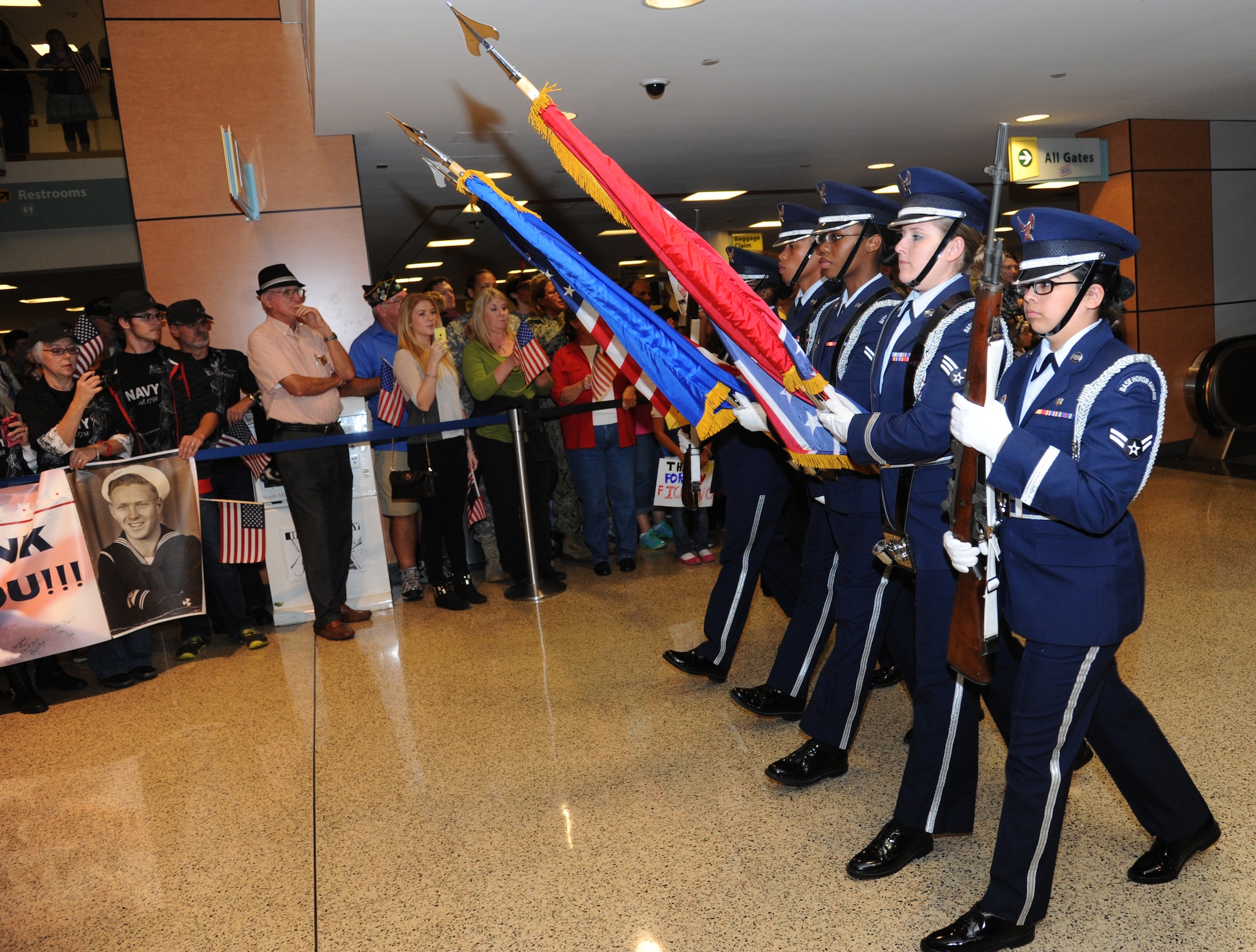 The Keesler Honor Guard leads World War II veterans with the final Mississippi Gulf Coast Honor Flight as they are welcomed  at the Gulfport/Biloxi International Airport from Washington, D.C., Nov. 5, 2013. The Honor Flight is a nonprofit program that sends veterans to Washington, D.C., to see national monuments. Throughout the three years of the honor flight program, 592 veterans have participated.  (U.S. Air Force photo by Kemberly Groue)