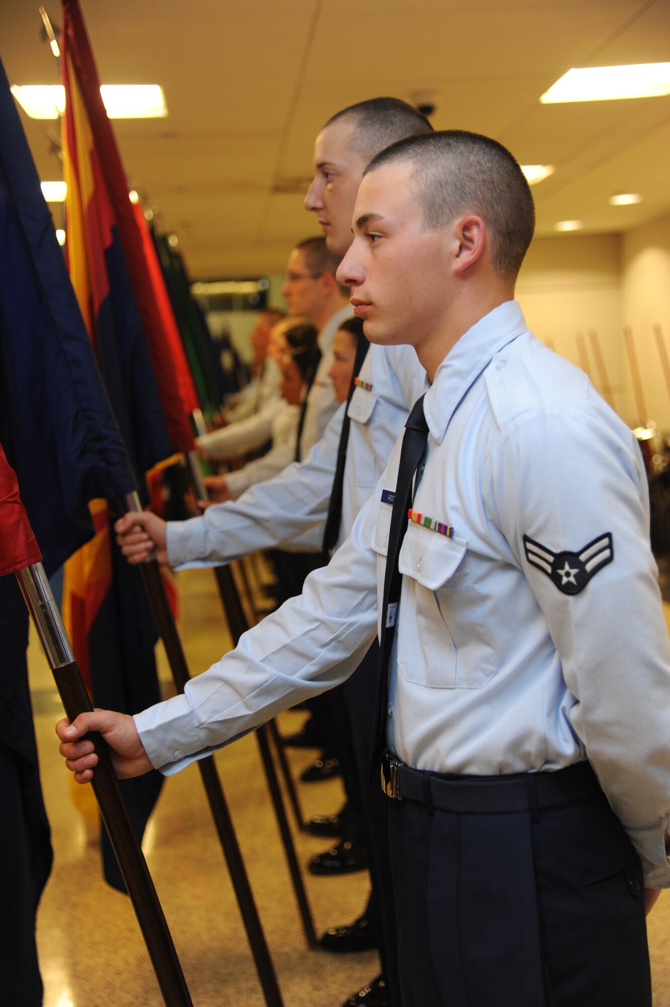 Airman 1st Class Jordan Aponte, 336th Training Squadron, holds one of the 50 state flags at the Gulfport/Biloxi International Airport in preparation for the arrival of World War II veterans with the final Mississippi Gulf Coast Honor Flight from Washington, D.C., Nov. 5, 2013. The Honor Flight is a nonprofit program that sends veterans to Washington, D.C., to see national monuments. Throughout the three years of the honor flight program, 592 veterans have participated.  (U.S. Air Force photo by Kemberly Groue)