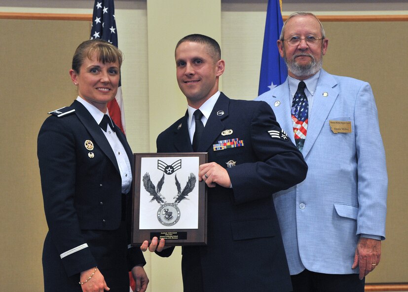 Senior Airman Trey Stone, 741st Security Forces Squadron, center, receives the Academic Achievement Award at the Airman Leadership School Class 14-A graduation banquet.  Shown presenting the award are Col. Marné Deranger, 341st Missile Wing vice commander, and Denis Miller, Malmstrom Retiree Association.  The Academic Achievement Award denotes excellence as a scholar and is presented to the student with the highest academic standing, excluding the John L. Levitow Award recipient.  The graduation banquet was held Nov. 5 at the Grizzly Bend.  (U.S. Air Force photo / John Turner)