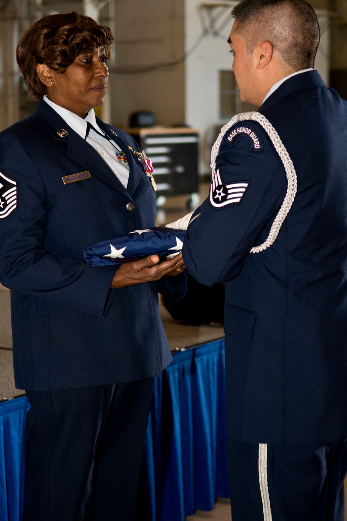 U.S. Air Force Master Sgt. Patricia McKinney-Bivens is presented a United States flag during her retirement ceremony on Nov. 3, 2013, Barksdale Air Force Base, La. McKinney-Bivens retired from the Air Force Reserve after 30 years of service. (U.S. Air Force photo by Master Sgt. Greg Steele/Released)