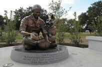 The Military Working Dog Teams’ National Monument, which includes a statue of a handler with his dog, was revealed Oct. 28, 2013 at Joint Base San Antonio-Lackland, Texas. There was also a wall with a montage of images of handlers with their canines and a statue of an Airman that was accompanied by four dog statues. (U.S. Air Force photo by Airman 1st Class Krystal M. Jeffers/Released)