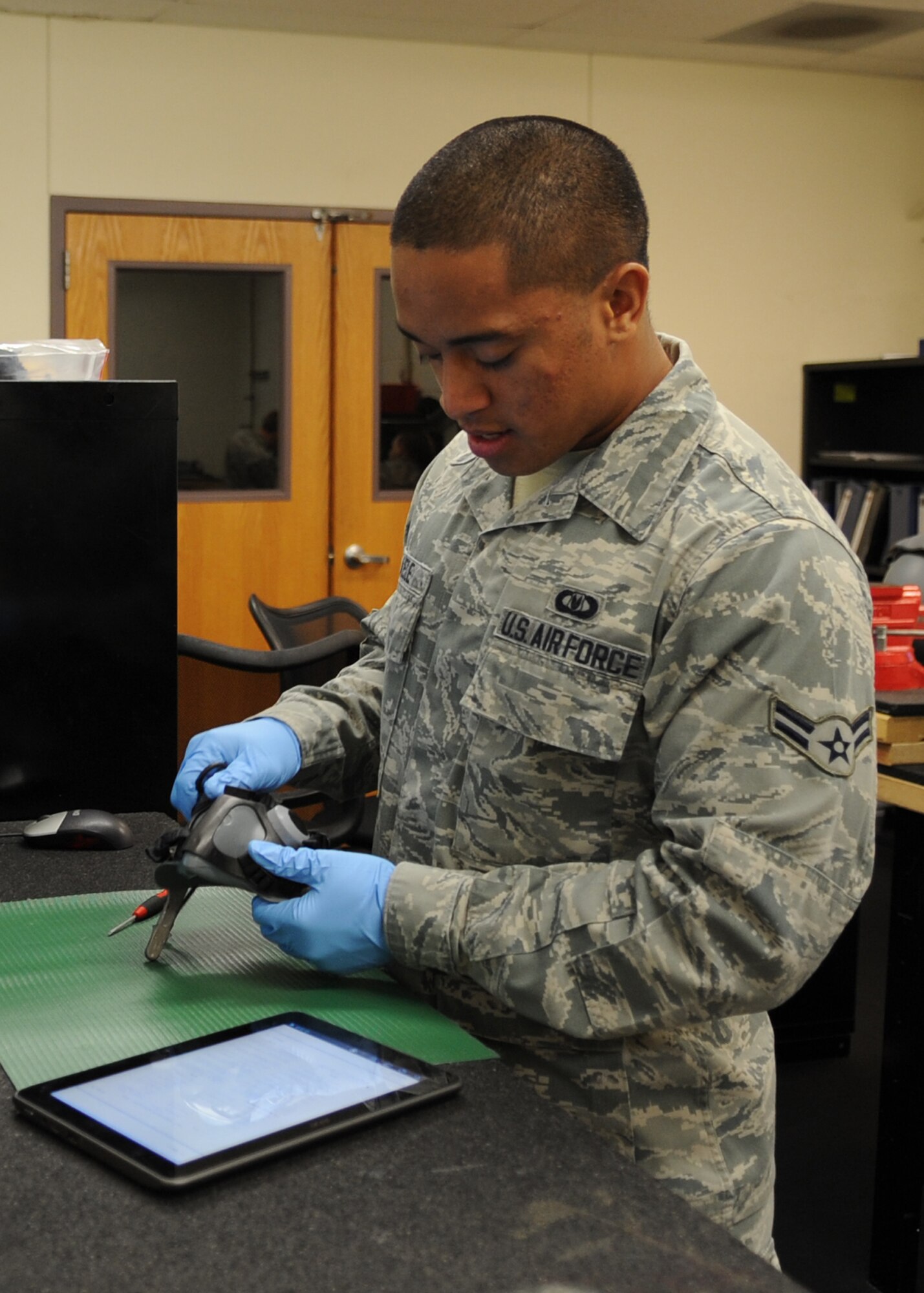 U.S. Air Force Airman 1st Class Pesamino Mikaele, 7th Operations Support Squadron, inspects an aircrew oxygen mask Oct. 29, 2013, at Dyess Air Force Base, Texas. Mikaele follows each step in his technical order to ensure masks are properly inspected and safe for flight. (U.S. Air Force photo by Senior Airman Shannon Hall/Released)