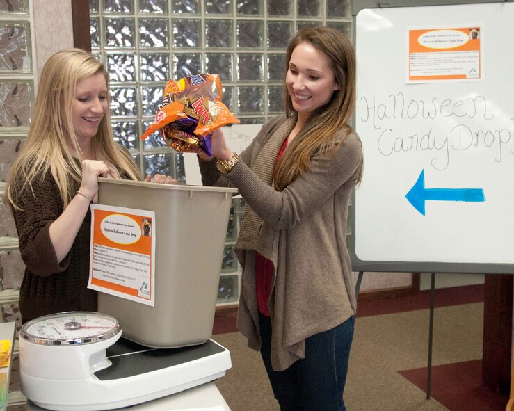 HANSCOM AIR FORCE BASE, Mass. -- Orlagh Pawlyk (left), Civilian Health Promotion Services coordinator, accepts candy from Avery Beal during Halloween Candy Drop at the Health and Wellness Center, Nov. 4. Hanscom personnel may drop off leftover Halloween candy through Nov. 7 at the HAWC. All donated candy will then be donated to the Bedford Veteran’s Hospital. (U.S. Air Force photo by Linda LaBonte Britt)