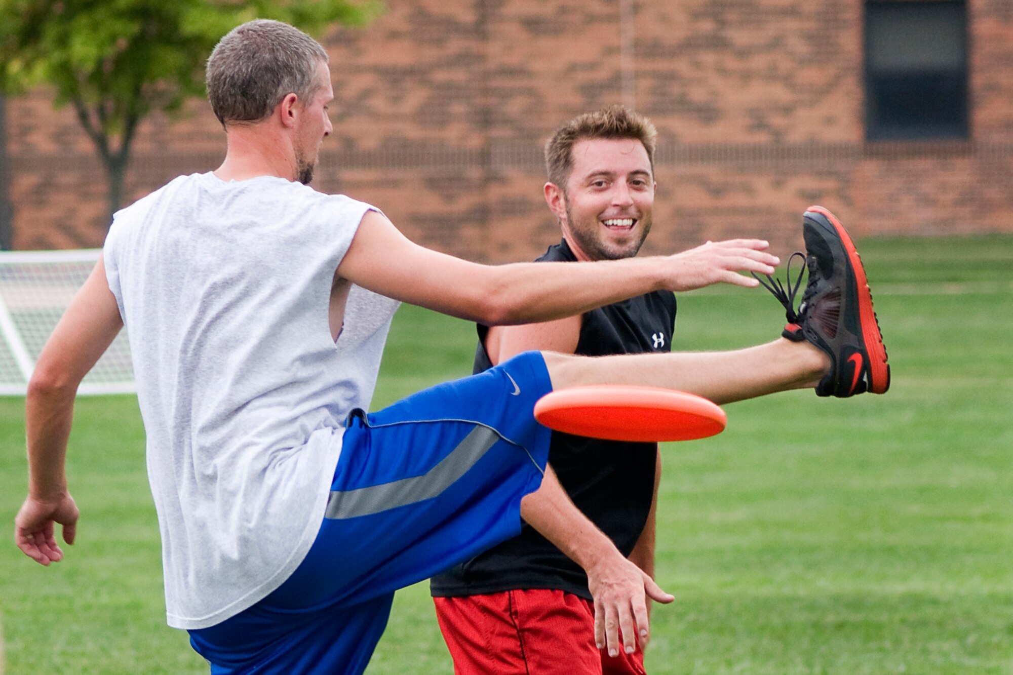 Brian Wright zips a disc past Cory Walters during a game of ultimate at Grissom Air Reserve Base, Ind., Aug. 8, 2013. Wright is a Grissom combat readiness technician and Walters is a 434th Civil Engineer Squadron biological scientist. (U.S. Air Force photo/Tech. Sgt. Mark R. W. Orders-Woempner)