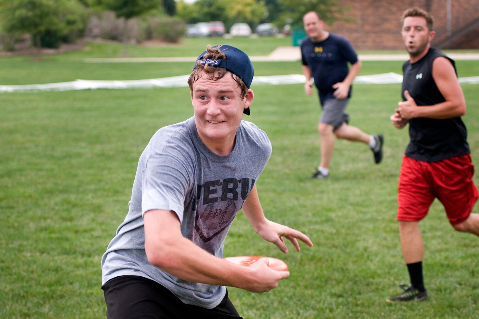 Andrew Robinson, son of Capt. Chris Robinson, 72nd Air Refueling Squadron assistant flight commander, throws a disc during a game of ultimate at Grissom Air Reserve Base, Ind., Aug. 8, 2013. Certain Grissom personnel and their family members gather together each Tuesday and Thursday in the summer to play a game on their lunch hour. (U.S. Air Force photo/Tech. Sgt. Mark R. W. Orders-Woempner)