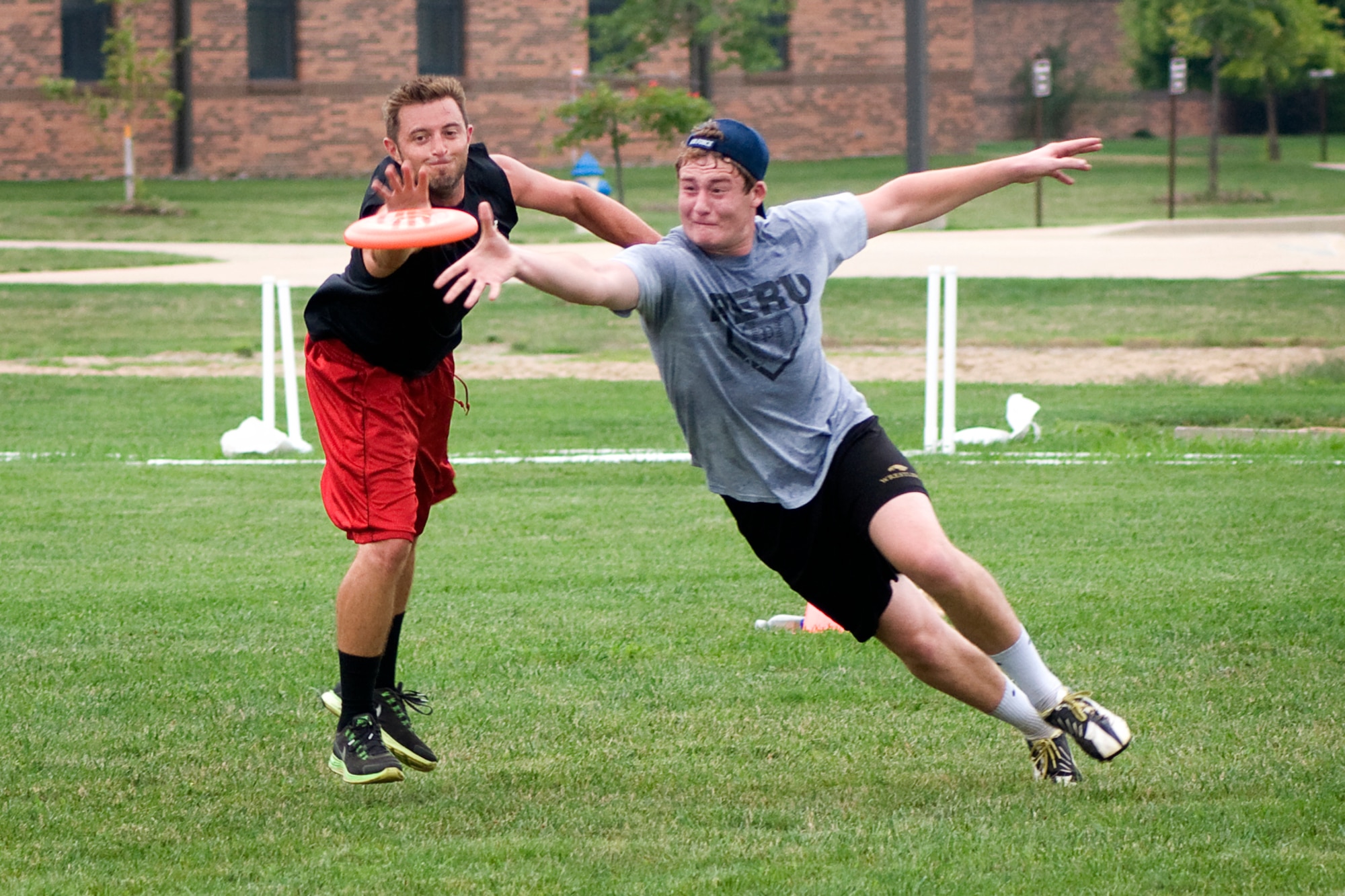 Brian Wright, left, and Andrew Robinson fight for a disc during a game of ultimate at Grissom Air Reserve Base, Ind., Aug. 8, 2013. Robinson is a son of Capt. Chris Robinson, 72nd Air Refueling Squadron assistant flight commander, and Wright is a Grissom combat readiness technician. (U.S. Air Force photo/Tech. Sgt. Mark R. W. Orders-Woempner)