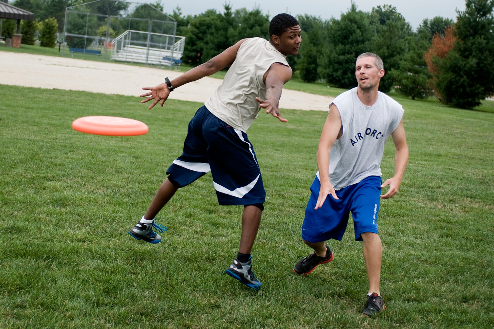Cory Walters slips a disc past Jamail Baldwin during a game of ultimate at Grissom Air Reserve Base, Ind., Aug. 8. 2013. Grissom personnel gather together each Tuesday and Thursday in the summer to play a game on their lunch hour. (U.S. Air Force photo/Tech. Sgt. Mark R. W. Orders-Woempner)