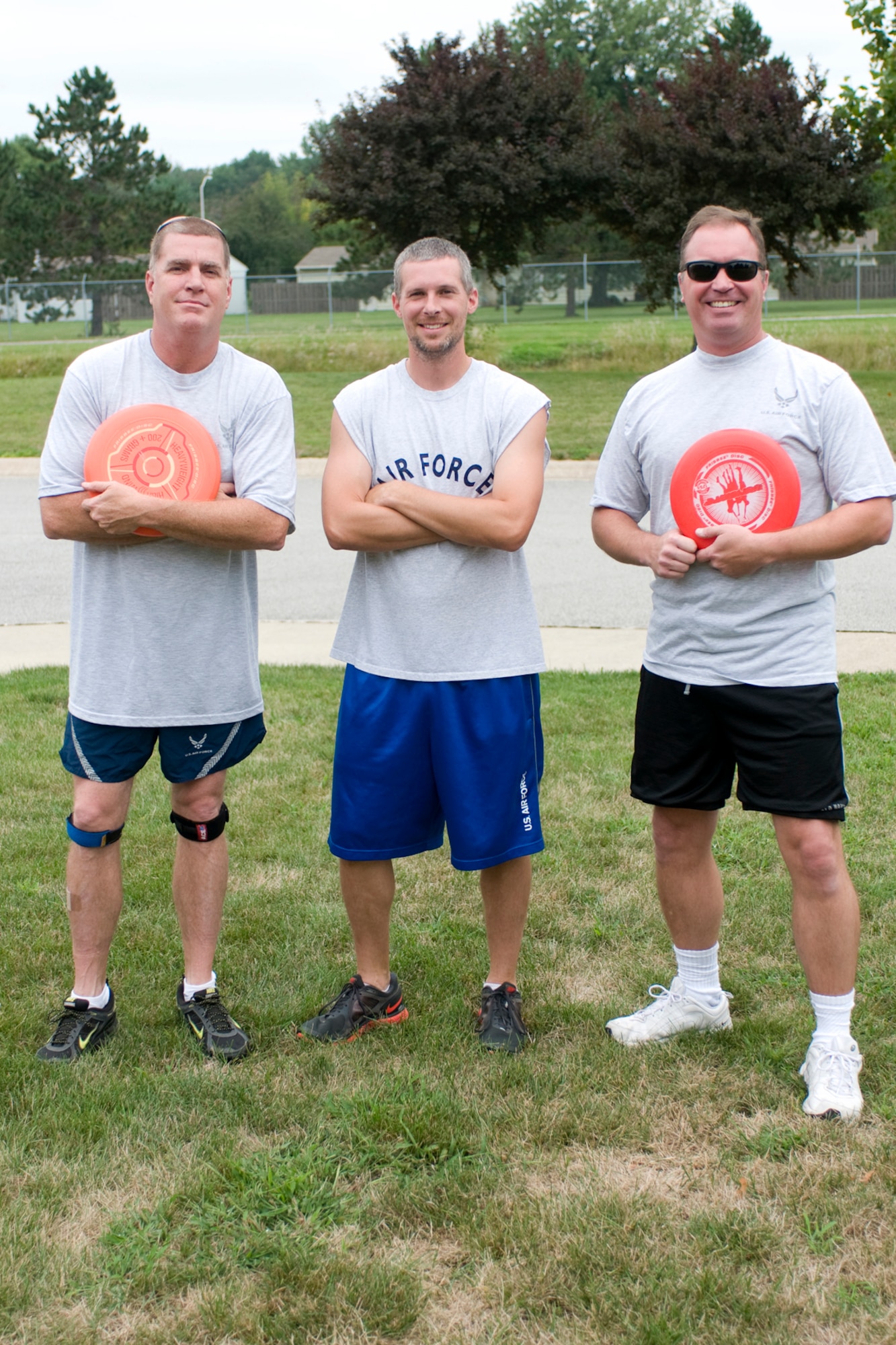 From left to right, Mark Copp, Cory Walters and Joe Austin Jr. pose for a photo prior to playing in a game of ultimate at Grissom Air Reserve Base, Ind., Aug. 8. 2013. Copp is a 434th Operations Support Squadron combat crew communications superintendent, Walters is a 434th Civil Engineer Squadron biological scientist and Austin is a 434th OSS chief of current operations. (U.S. Air Force photo/Tech. Sgt. Mark R. W. Orders-Woempner)